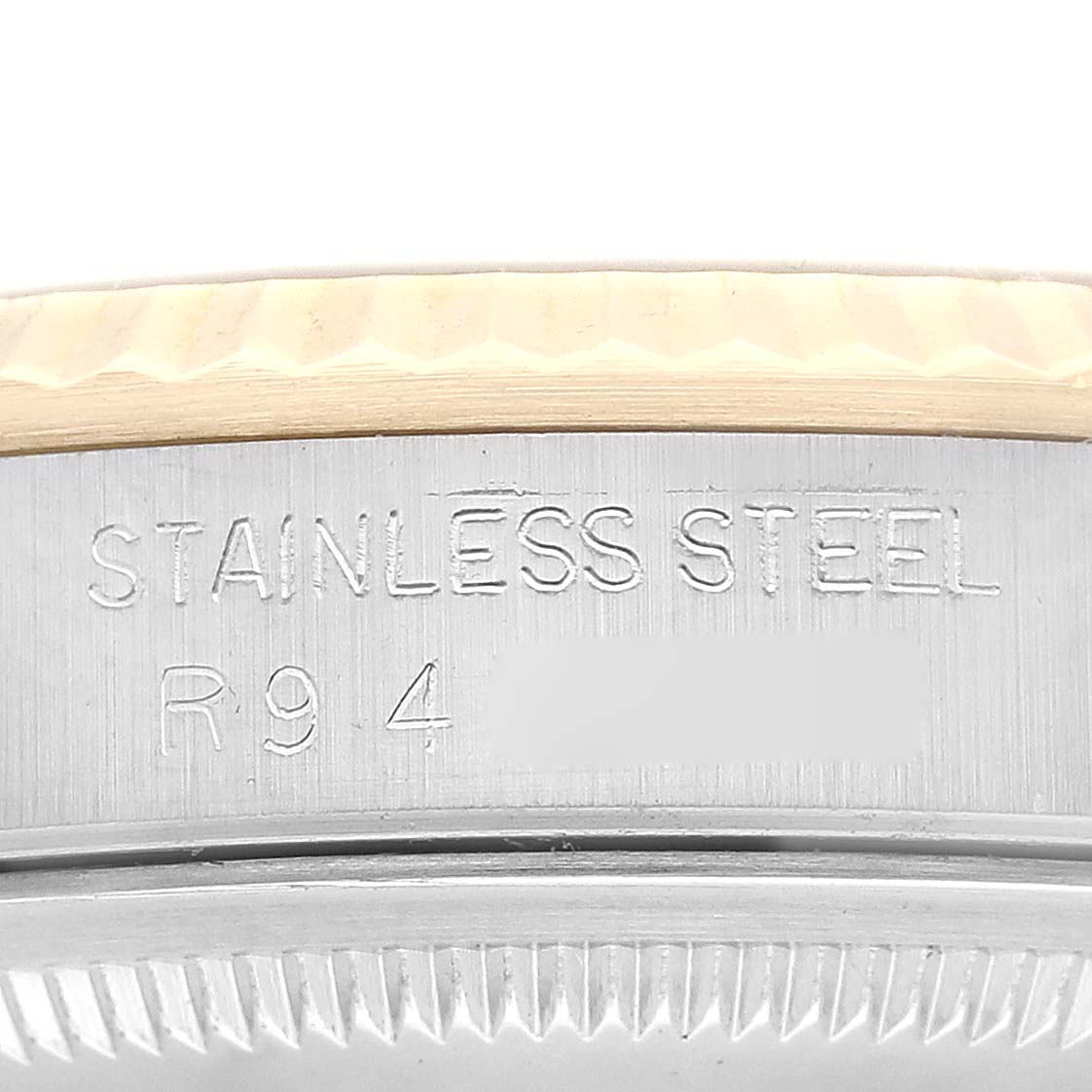 This close-up image shows the side engraving of a stainless-steel Rolex Datejust 16233 Men's Steel and Gold (two tone) Champagne Dial 16233 Men's Steel and Gold (two tone) Champagne Dial watch case.