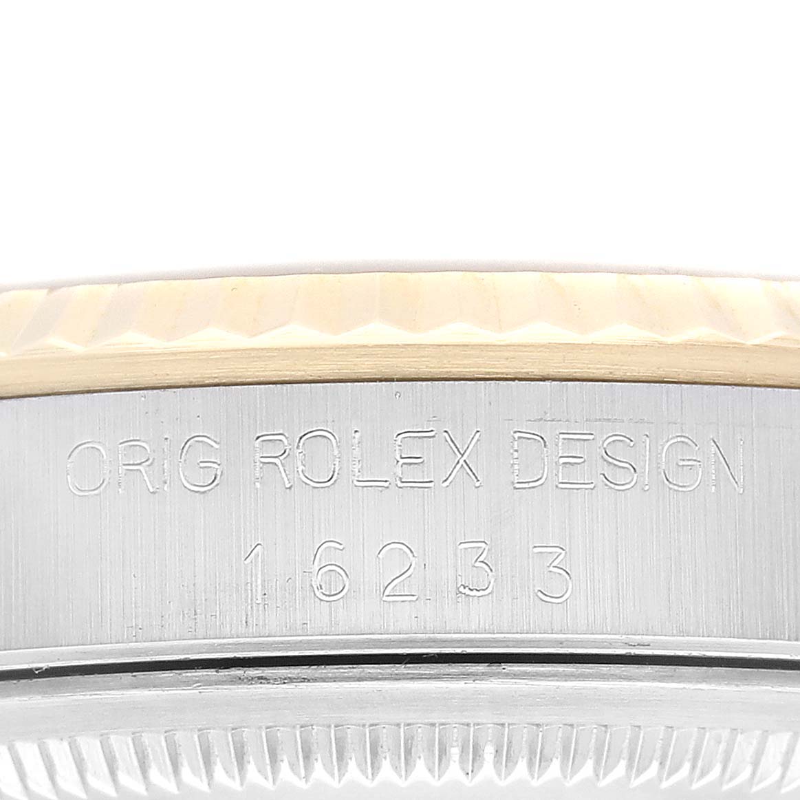 This image shows a close-up angle of the engraved side view of a Rolex Datejust 16233 Men's Steel and Gold (two tone) Champagne Dial 16233 Men's Steel and Gold (two tone) Champagne Dial watch, highlighting the bezel and model number.