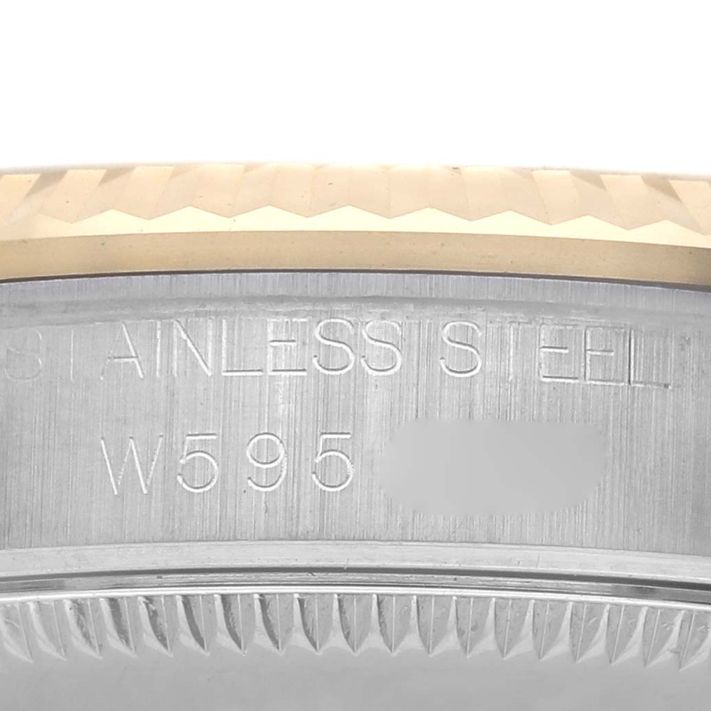 The image shows a close-up of the side of a Rolex Mid-Size 68273 Women's Steel and Gold (two tone) Champagne Dial 68273 Women's Steel and Gold (two tone) Champagne Dial watch, highlighting the stainless steel inscription and serial number.