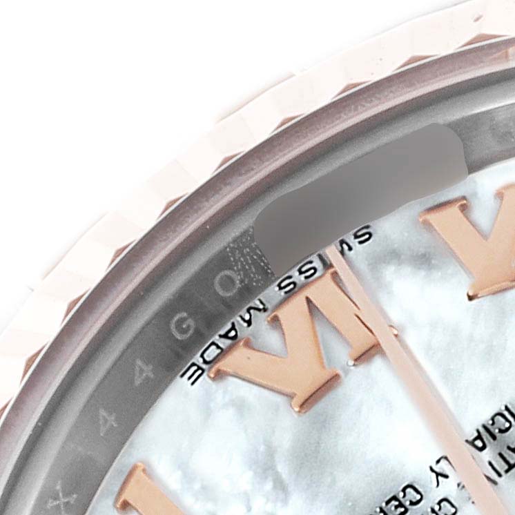 The image shows a close-up of the Rolex Datejust 179171NR Women's Steel and Gold (two tone) Mother of Pearl Dial 179171NR Women's Steel and Gold (two tone) Mother of Pearl Dial’s bezel and part of the dial with Roman numerals and "SWISS MADE."