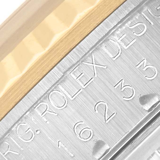 The image shows a close-up of the side engraving and bezel detail of a Rolex Datejust 16233 Men's Steel and Gold (two tone) Champagne Dial 16233 Men's Steel and Gold (two tone) Champagne Dial watch.