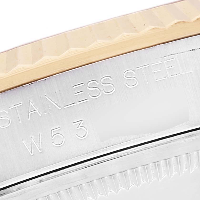 This image shows a close-up angle of the case and bezel of a Rolex Datejust 16233 Men's Steel and Gold (two tone) Beige Dial 16233 Men's Steel and Gold (two tone) Beige Dial watch, revealing the "Stainless Steel" engraving.