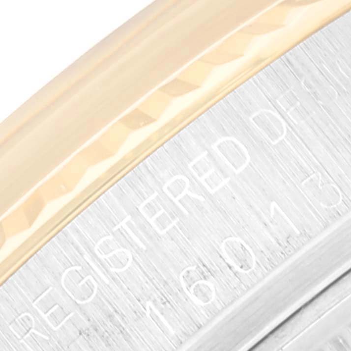 This close-up image shows part of the bezel and engraved caseback of a Vintage Collection Rolex watch.