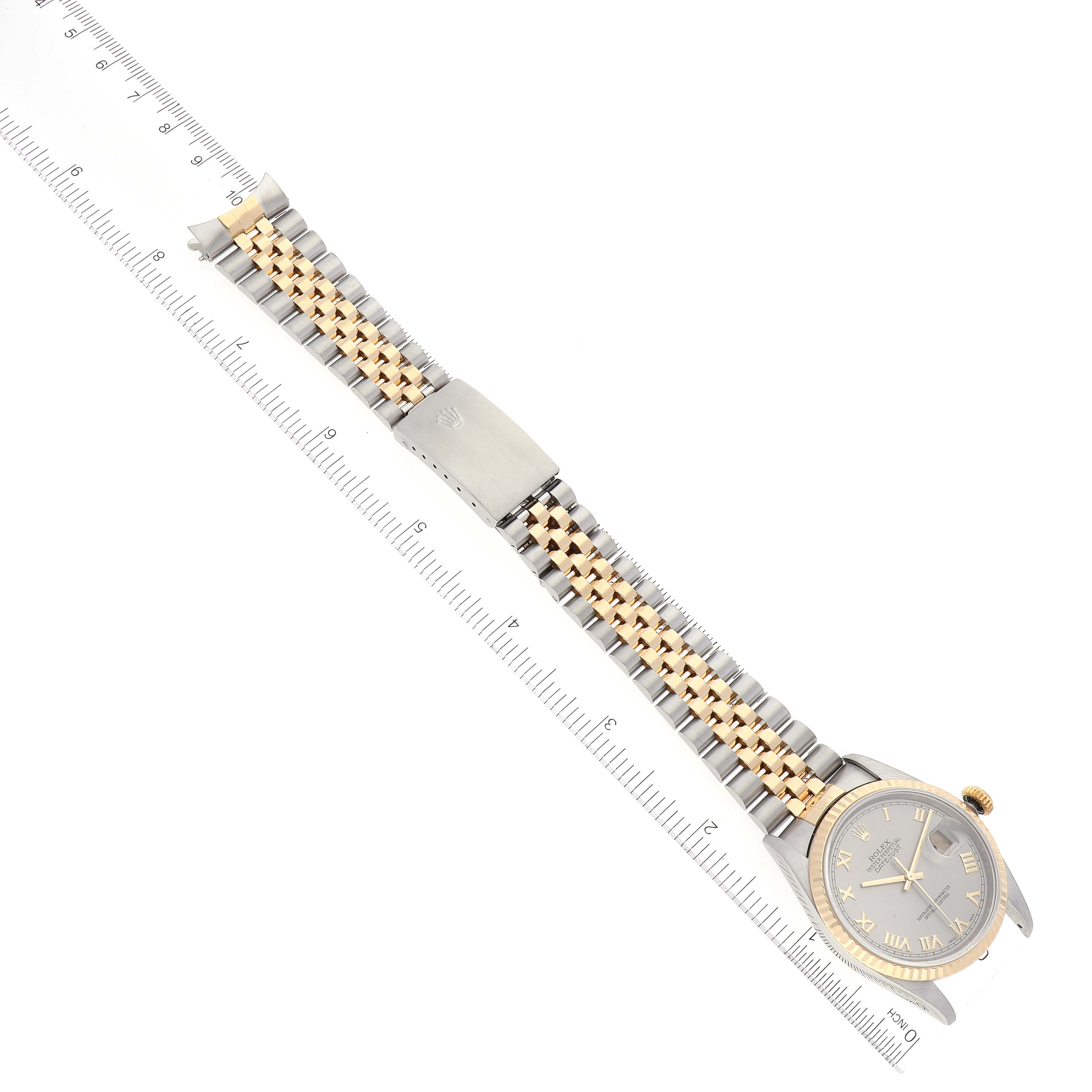 The image shows a Rolex Datejust 16233 Men's Steel and Gold (two tone) Grey Dial 16233 Men's Steel and Gold (two tone) Grey Dial watch from an overhead angle, highlighting its face, bracelet, and clasp against a ruler.