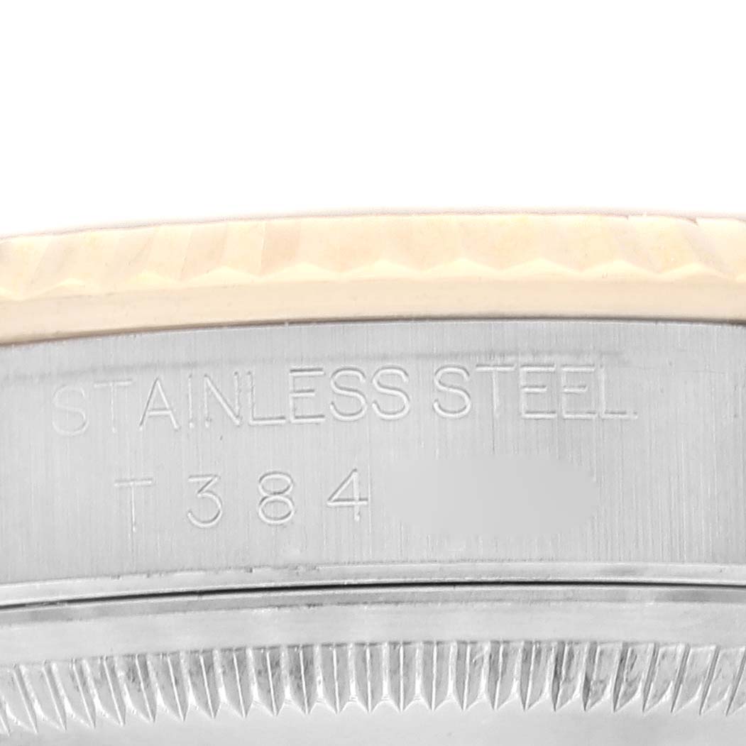 This close-up image of the Rolex Datejust 16233 Men's Steel and Gold (two tone) Grey Dial 16233 Men's Steel and Gold (two tone) Grey Dial watch shows the stainless steel case and engraved text.