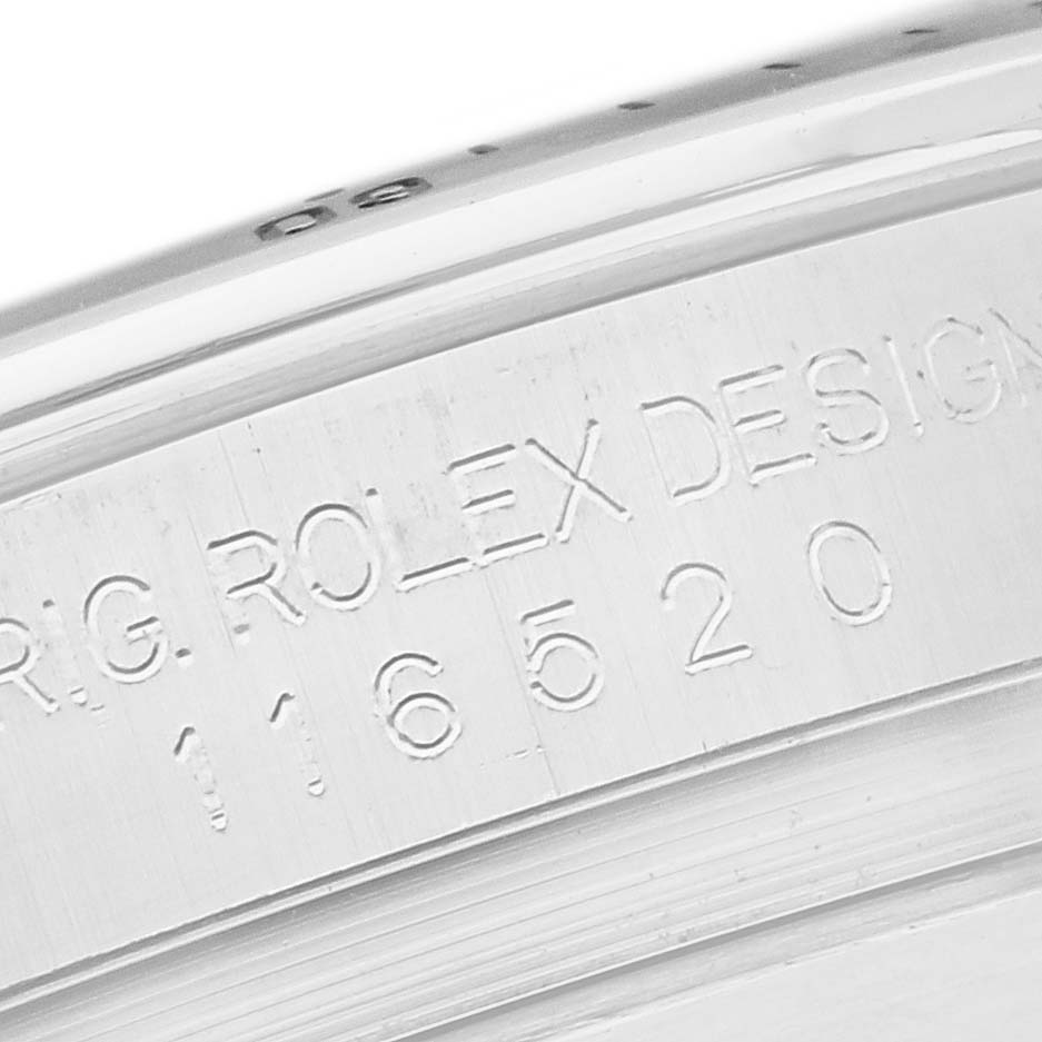The image shows a close-up of the side of a Rolex Daytona 116520 Men's Stainless Steel White Dial 116520 Men's Stainless Steel White Dial, displaying engraved model and design information.