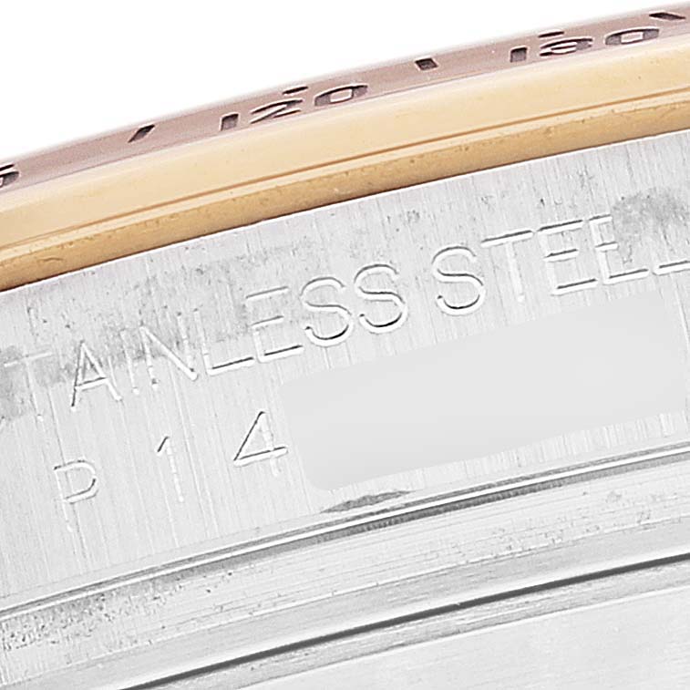 This close-up image shows the side of a Rolex Daytona 16523 Men's Steel and Gold (two tone) White Dial 16523 Men's Steel and Gold (two tone) White Dial watch case with part of the bezel and engraved "STAINLESS STEEL."