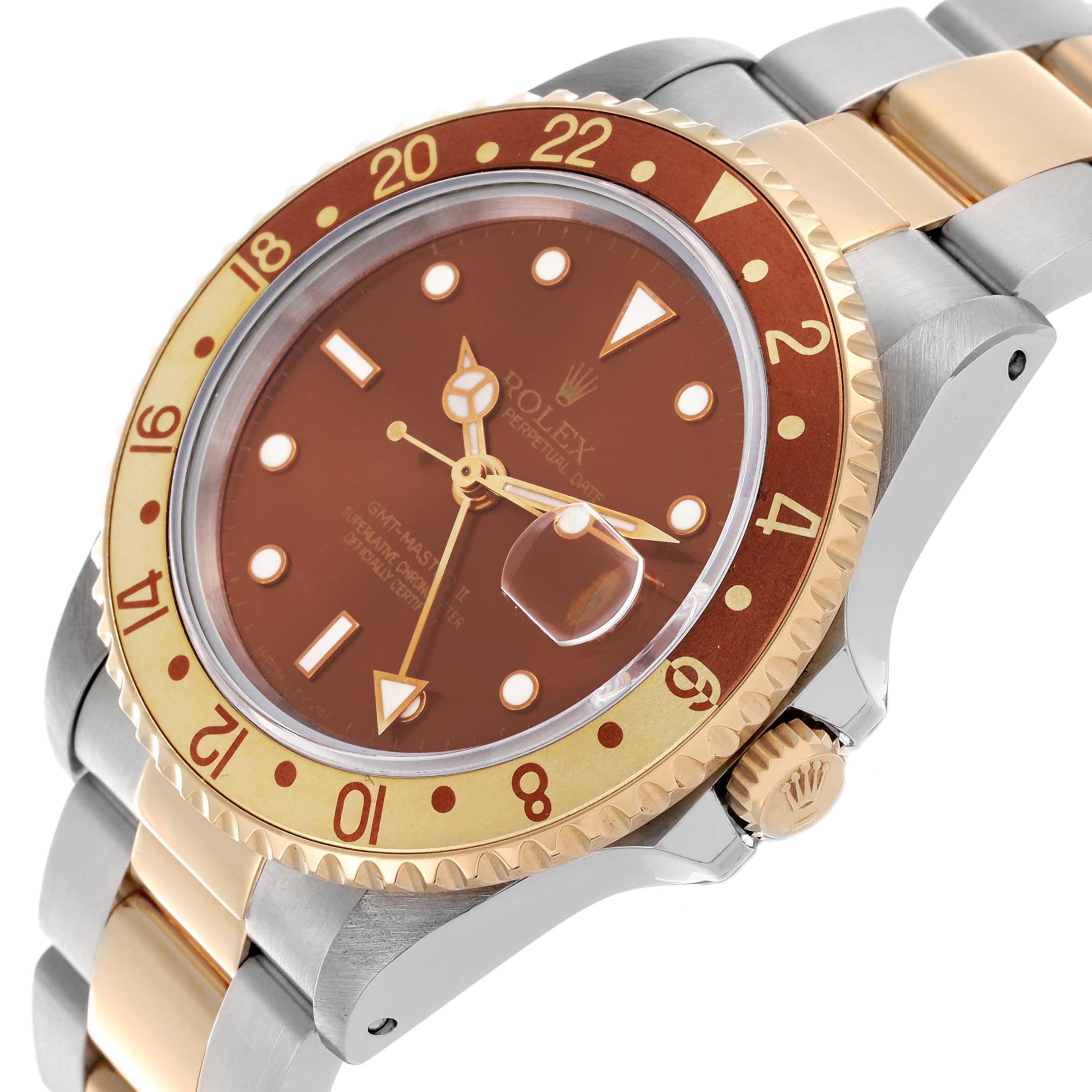 The Rolex GMT-Master 16713 Men's Steel and Gold (two tone) Brown Dial 16713 Men's Steel and Gold (two tone) Brown Dial watch is shown at an angle highlighting the dial, bezel, crown, and part of the bracelet.