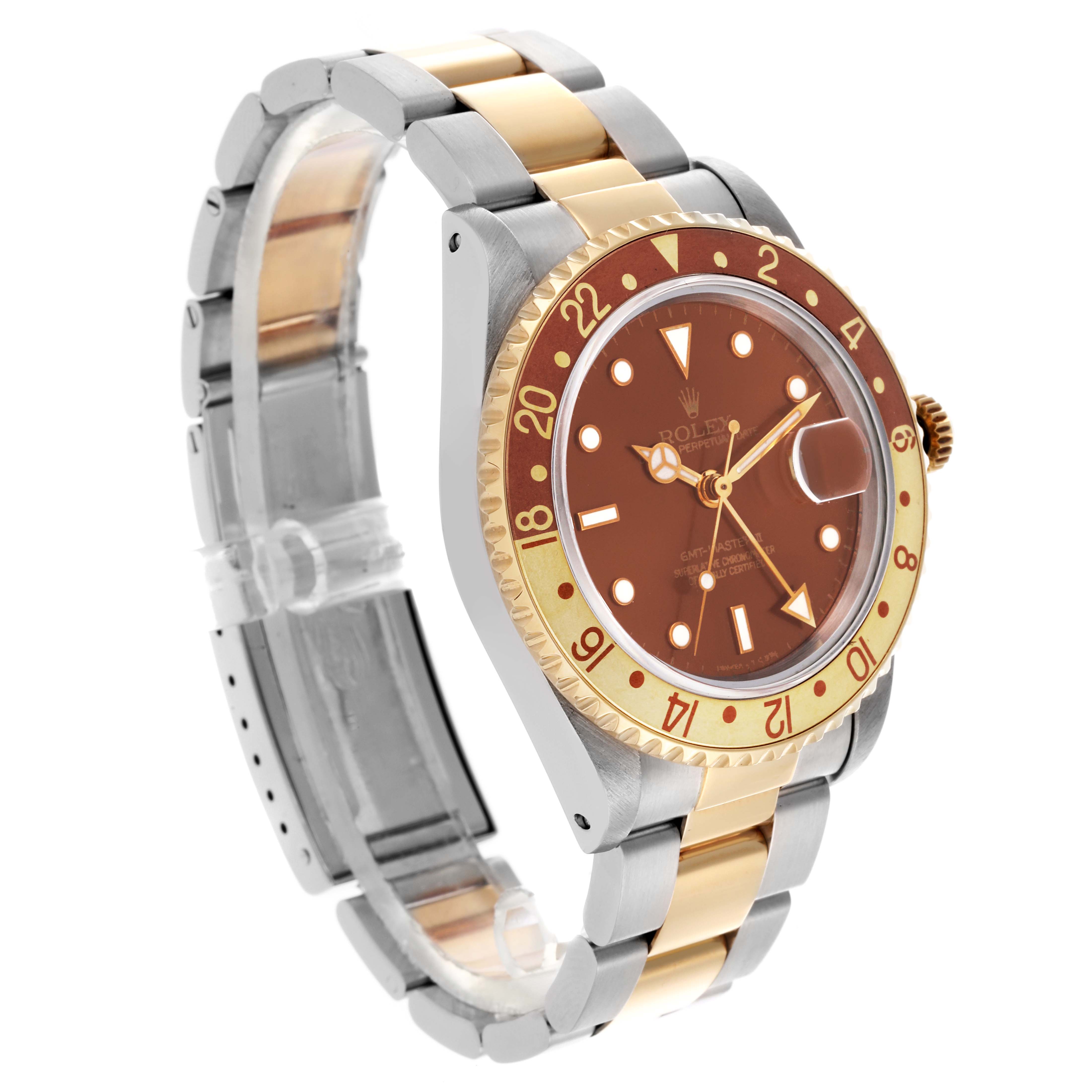 The Rolex GMT-Master 16713 Men's Steel and Gold (two tone) Brown Dial 16713 Men's Steel and Gold (two tone) Brown Dial watch is shown at a three-quarter angle, highlighting its bezel, dial, case, and two-tone bracelet.