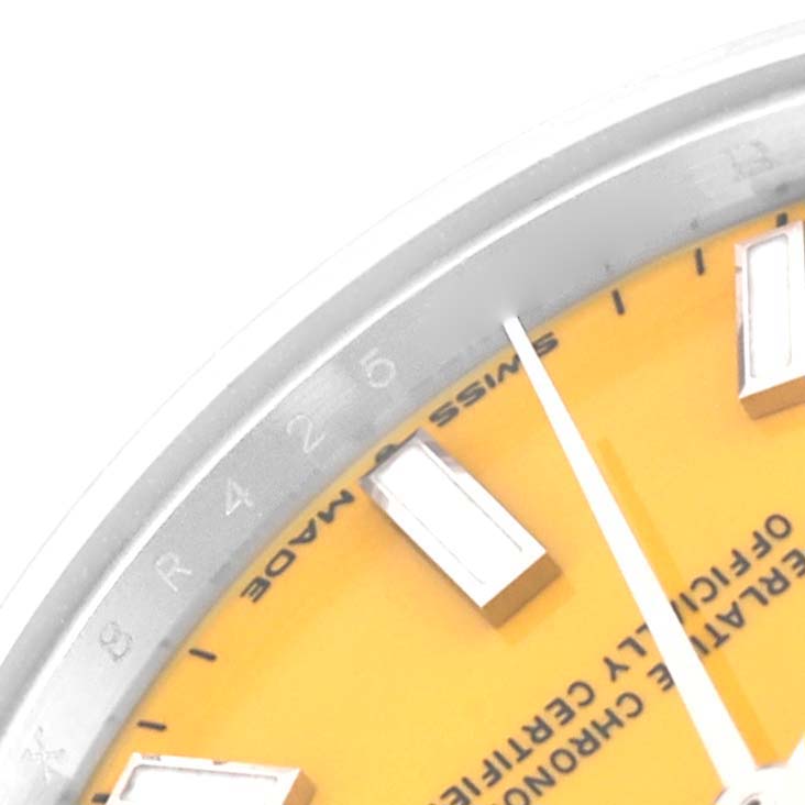 The image shows a close-up, partial view of the dial, indices, and minute hand of a Mid-Size Rolex watch.