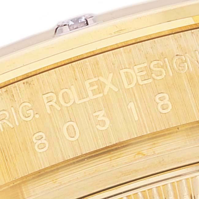 This close-up shows the side of the case of the Rolex Pearlmaster 80318 Women
s Yellow Gold White Dial 80318 Women
s Yellow Gold White Dial watch, featuring part of the engraved series number.