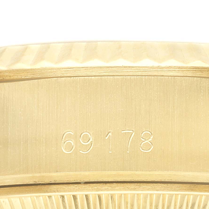 The image shows a close-up of the engraved serial number on the Rolex President 69178 Women's Yellow Gold Champagne Dial 69178 Women's Yellow Gold Champagne Dial watch case.