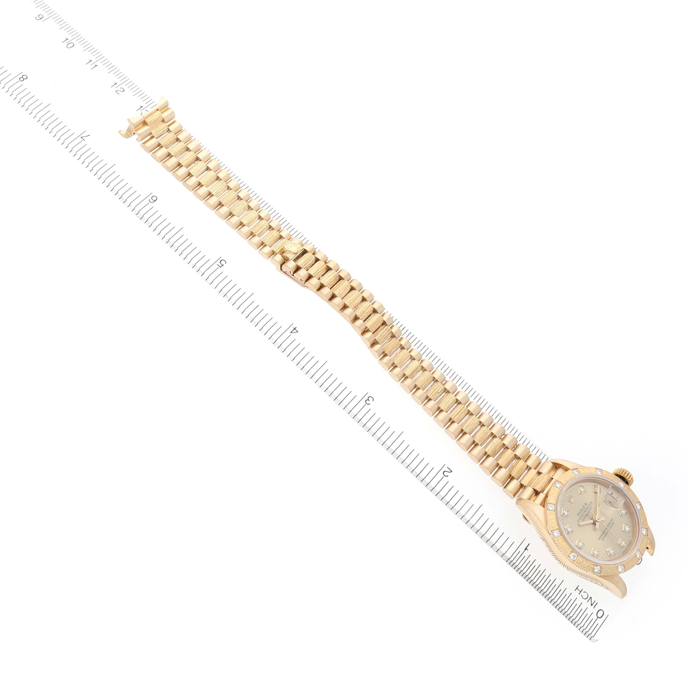The Rolex President 69288 Women's Yellow Gold Champagne Dial 69288 Women's Yellow Gold Champagne Dial watch is shown from a top angle, featuring the full bracelet and face with a ruler for scale.