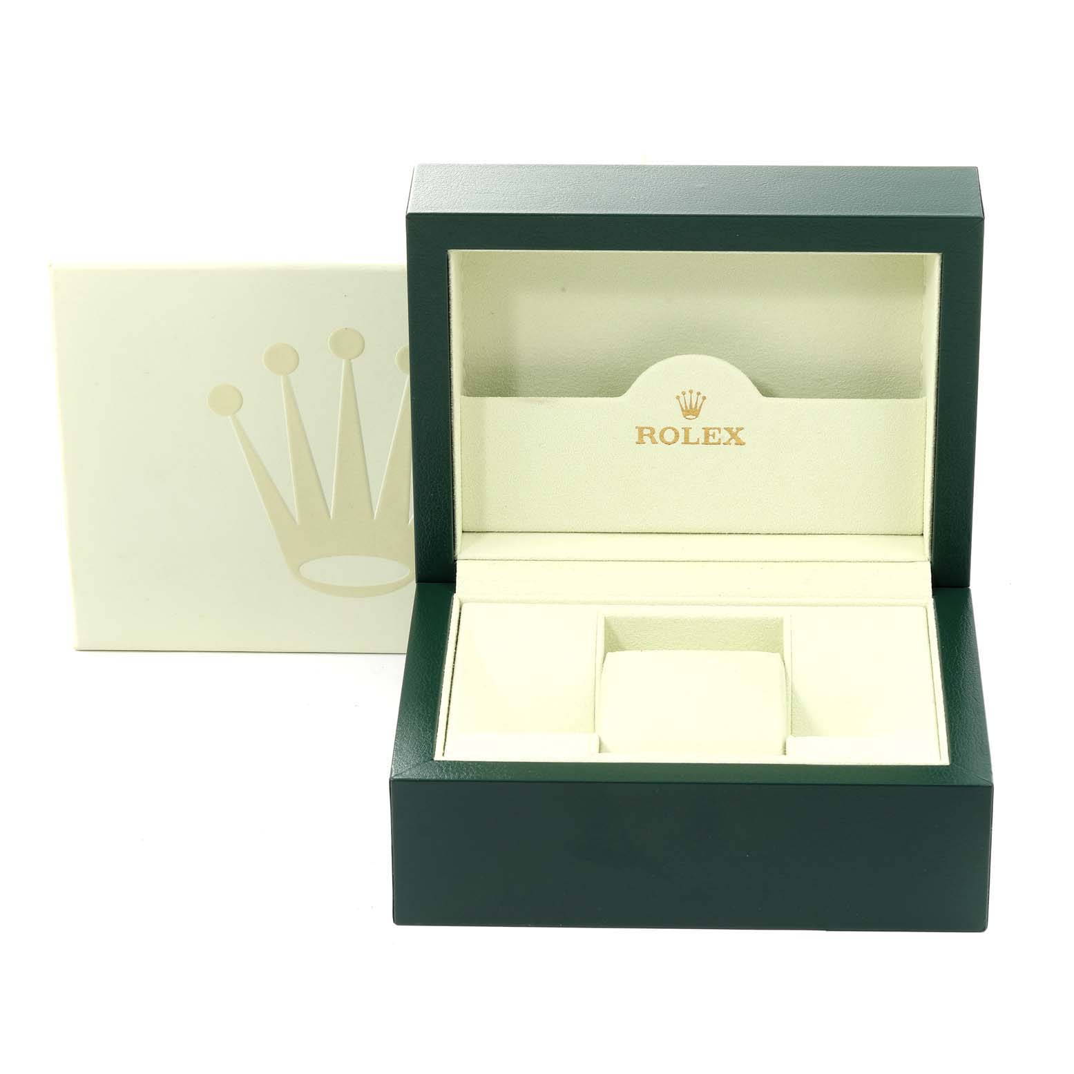 The image shows an open Rolex box for the President model, featuring its inside compartments and lid with branding.