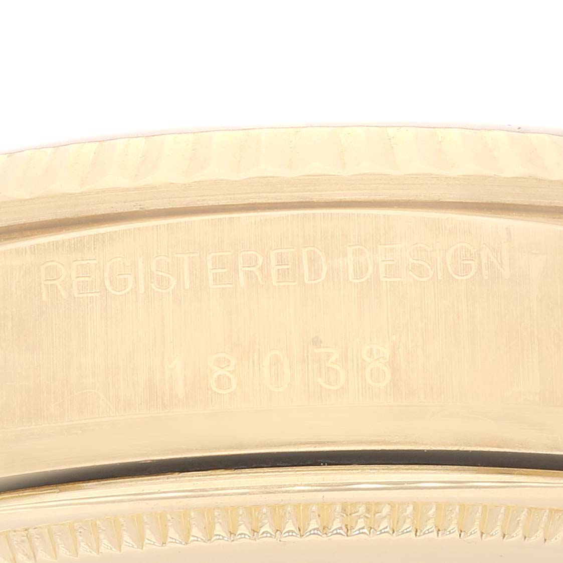 This close-up image shows the side of the bezel and case back for the Rolex President 18038 Men's Yellow Gold White Dial 18038 Men's Yellow Gold White Dial model, highlighting its engraved details.
