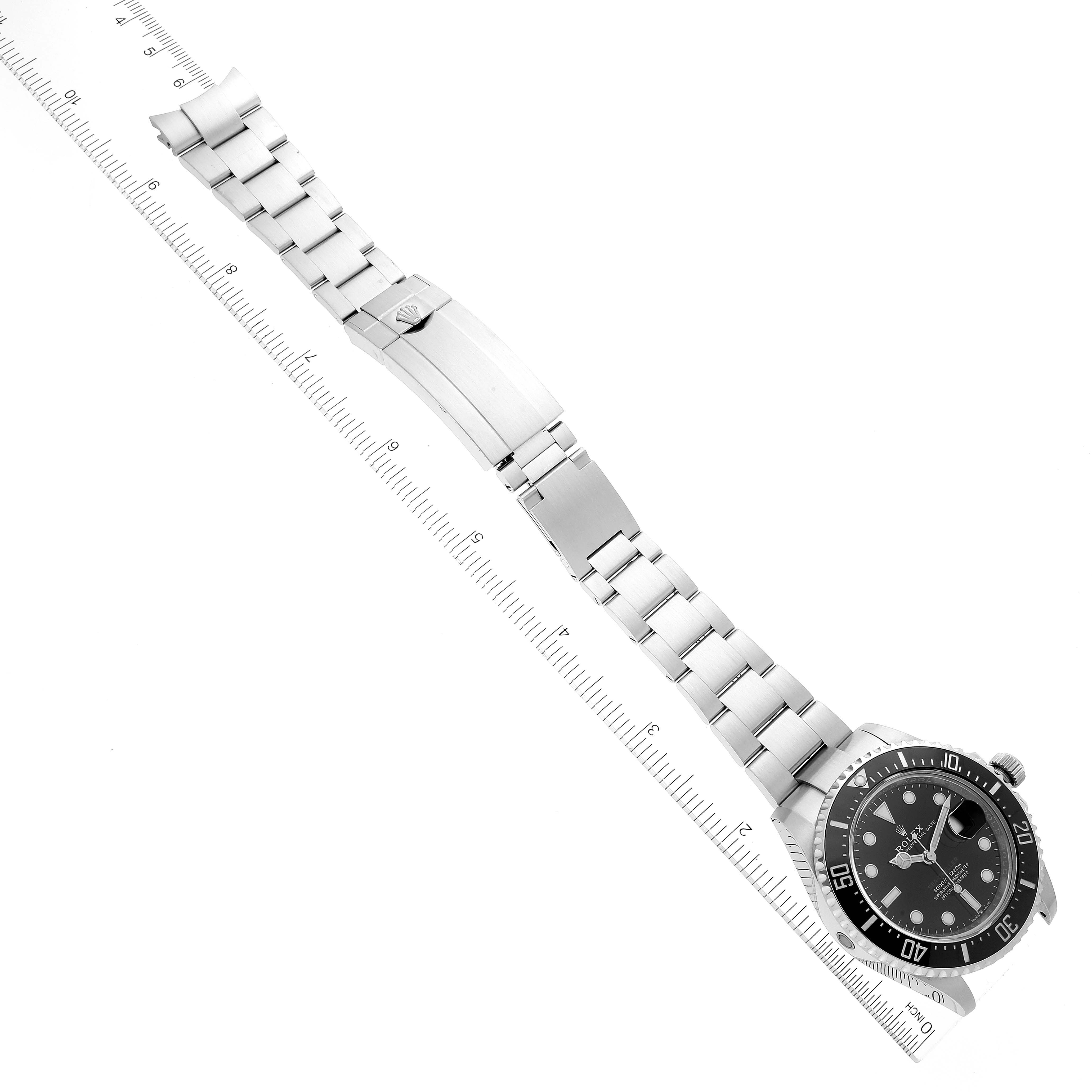 The image shows the full length of a Rolex Sea-Dweller 126600 Men's Stainless Steel Black Dial 126600 Men's Stainless Steel Black Dial watch, including its face, bezel, and metal bracelet strap, aligned with a ruler.