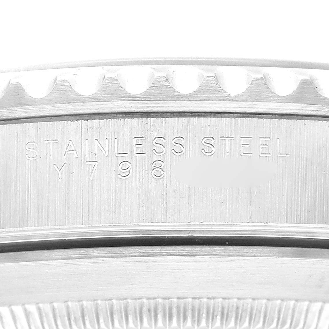 This image shows a close-up of the stainless steel case side of a Rolex Submariner 14060M Men
s Stainless Steel Black Dial 14060M Men
s Stainless Steel Black Dial, displaying the serial and material engraving.