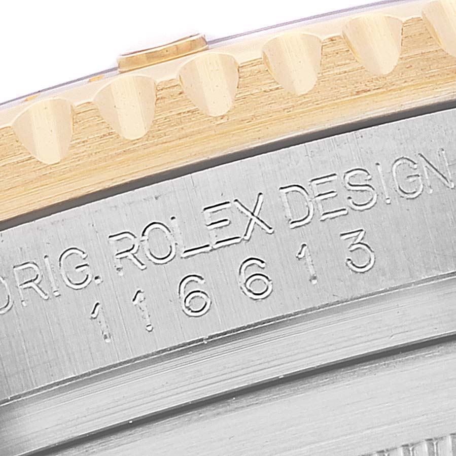 This image shows a close-up view of the bezel and engraved serial number on the side of the Rolex Submariner 116613 Men's Steel and Gold (two tone) Black Dial 116613 Men's Steel and Gold (two tone) Black Dial watch.