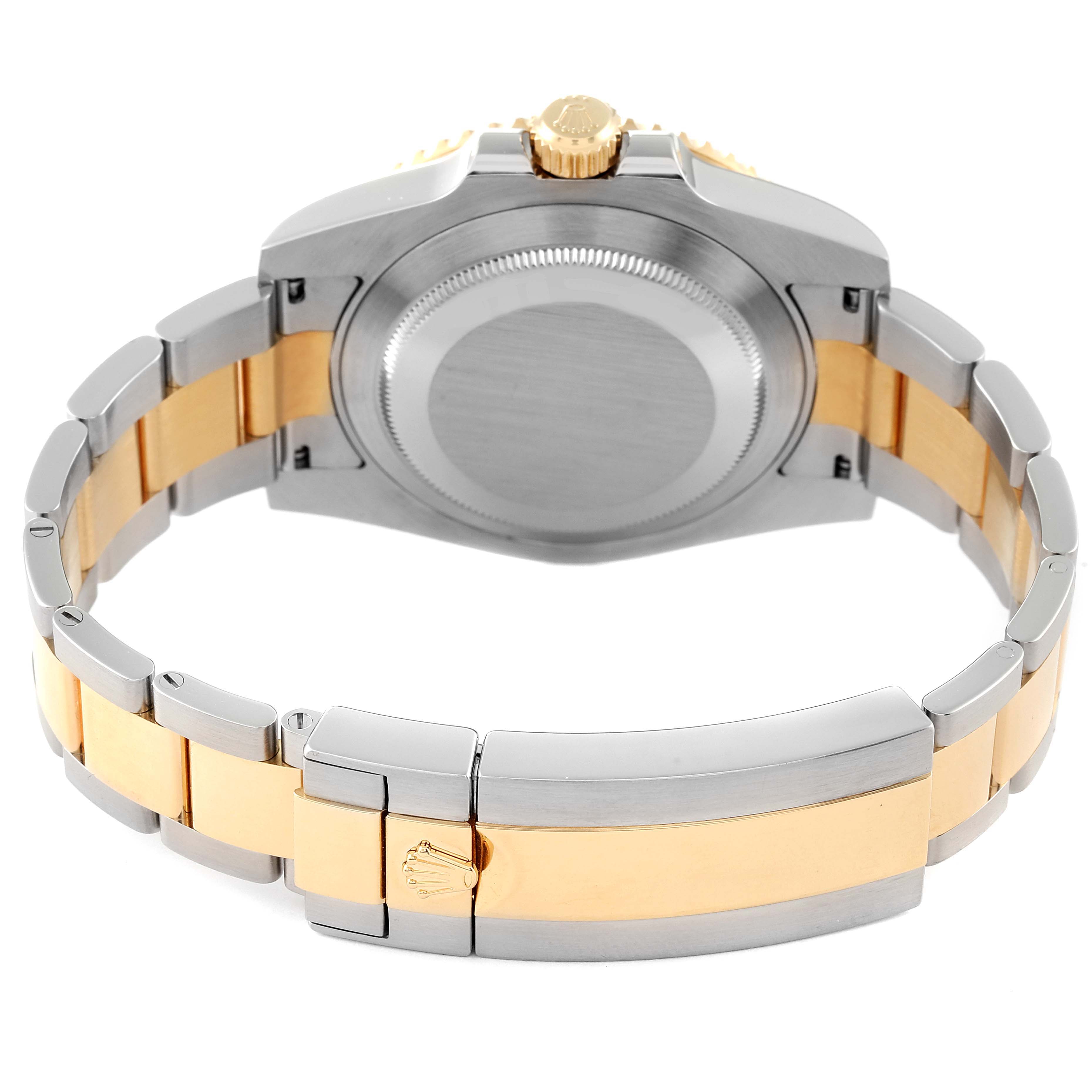 This photo shows the back and bracelet of a Rolex Submariner 116613 Men's Steel and Gold (two tone) Black Dial 116613 Men's Steel and Gold (two tone) Black Dial watch, highlighting the two-tone metal finish.