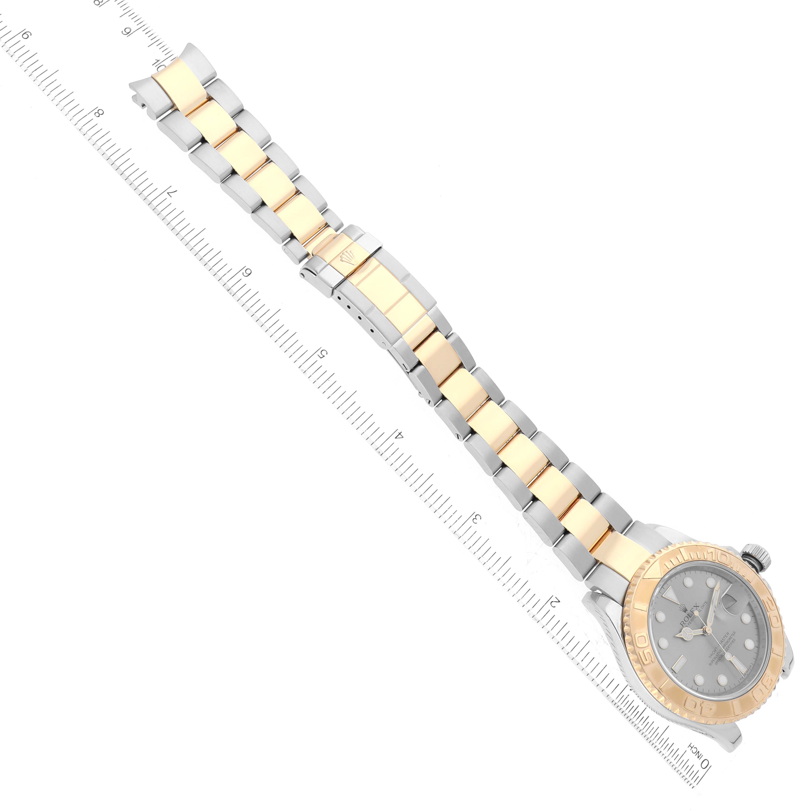 This image shows a Rolex Yacht-Master 16623 Men's Steel and Gold (two tone) Grey Dial 16623 Men's Steel and Gold (two tone) Grey Dial watch from an angled top view, highlighting its bracelet, bezel, dial, and a ruler beside it.