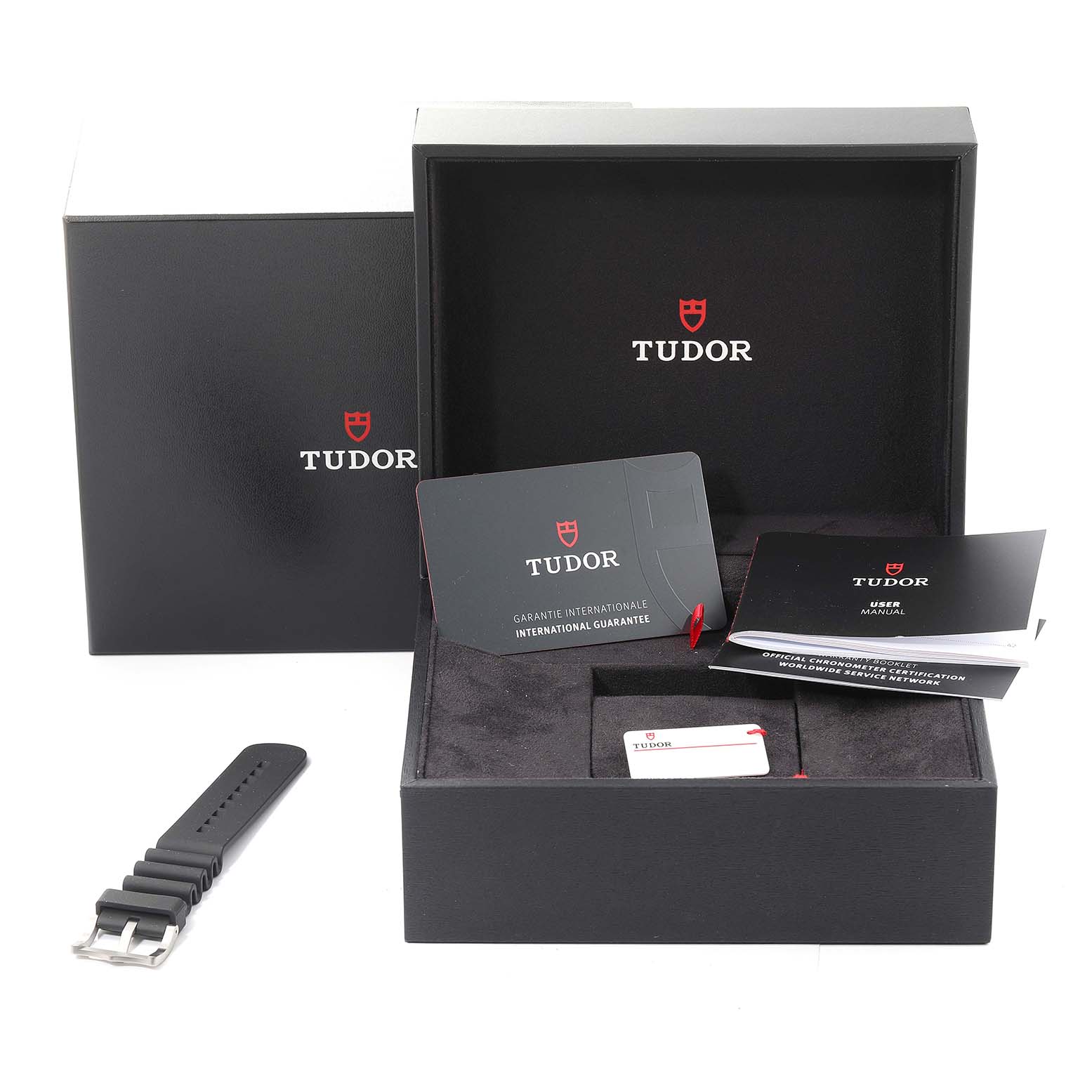 The image shows the packaging, user manuals, guarantee card, and an additional strap for a Tudor Pelagos 25600TN Men
s Titanium Black Dial 25600TN Men
s Titanium Black Dial watch.