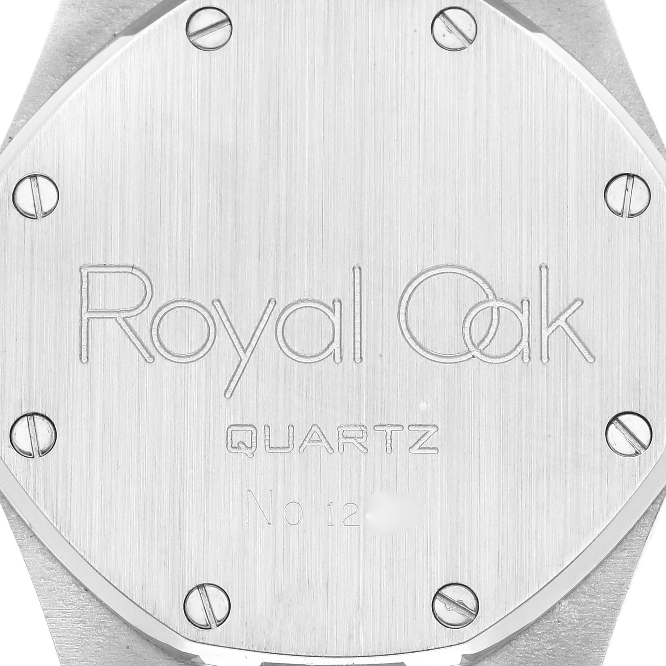 The image shows the case back of a Royal Oak Quartz watch by Audemars Piguet, displaying its engravings and screws.