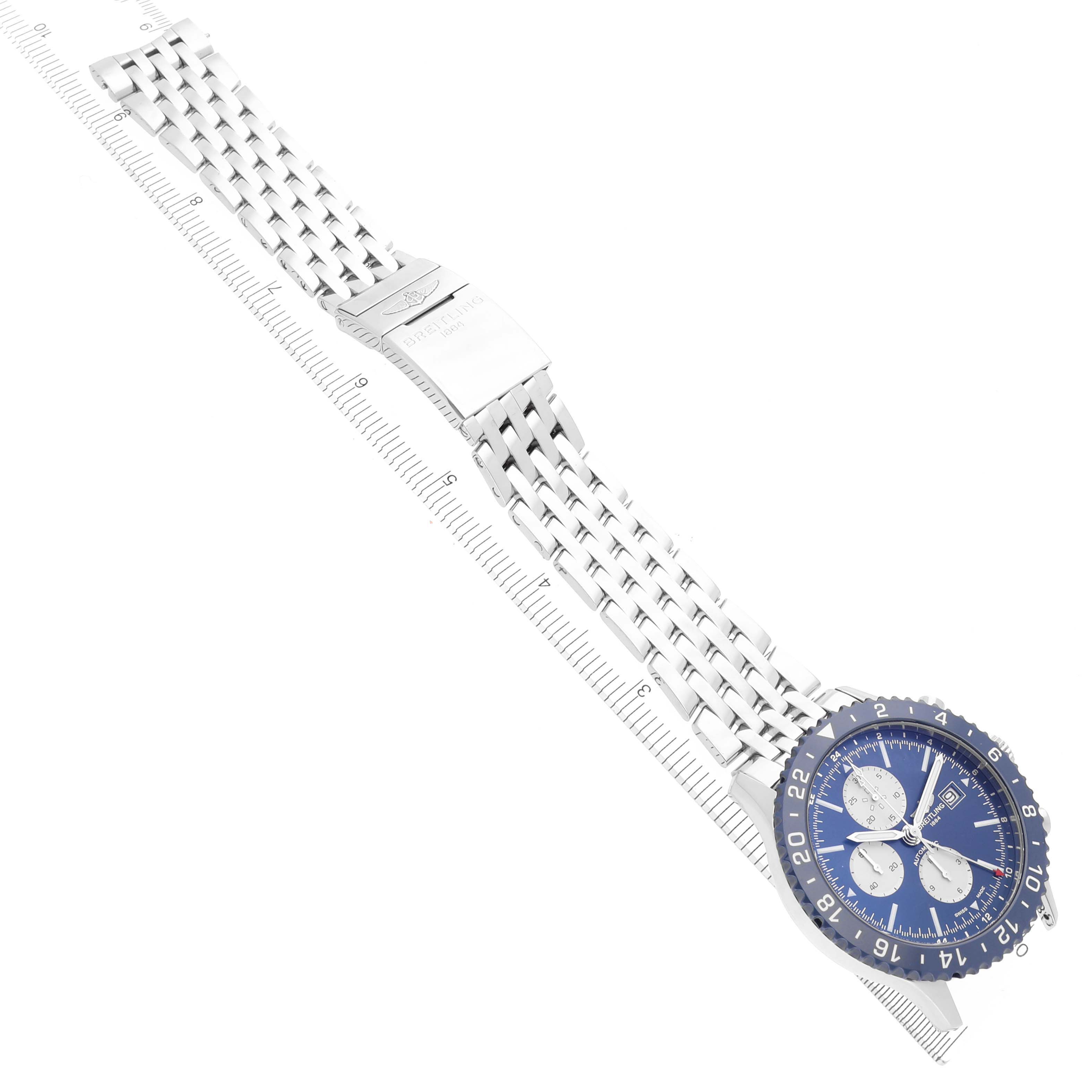 The Breitling Chronoliner Y24310 Men's Stainless Steel Blue Dial Y24310 Men's Stainless Steel Blue Dial watch is shown at an oblique angle, displaying its metal bracelet and blue dial with subdials.