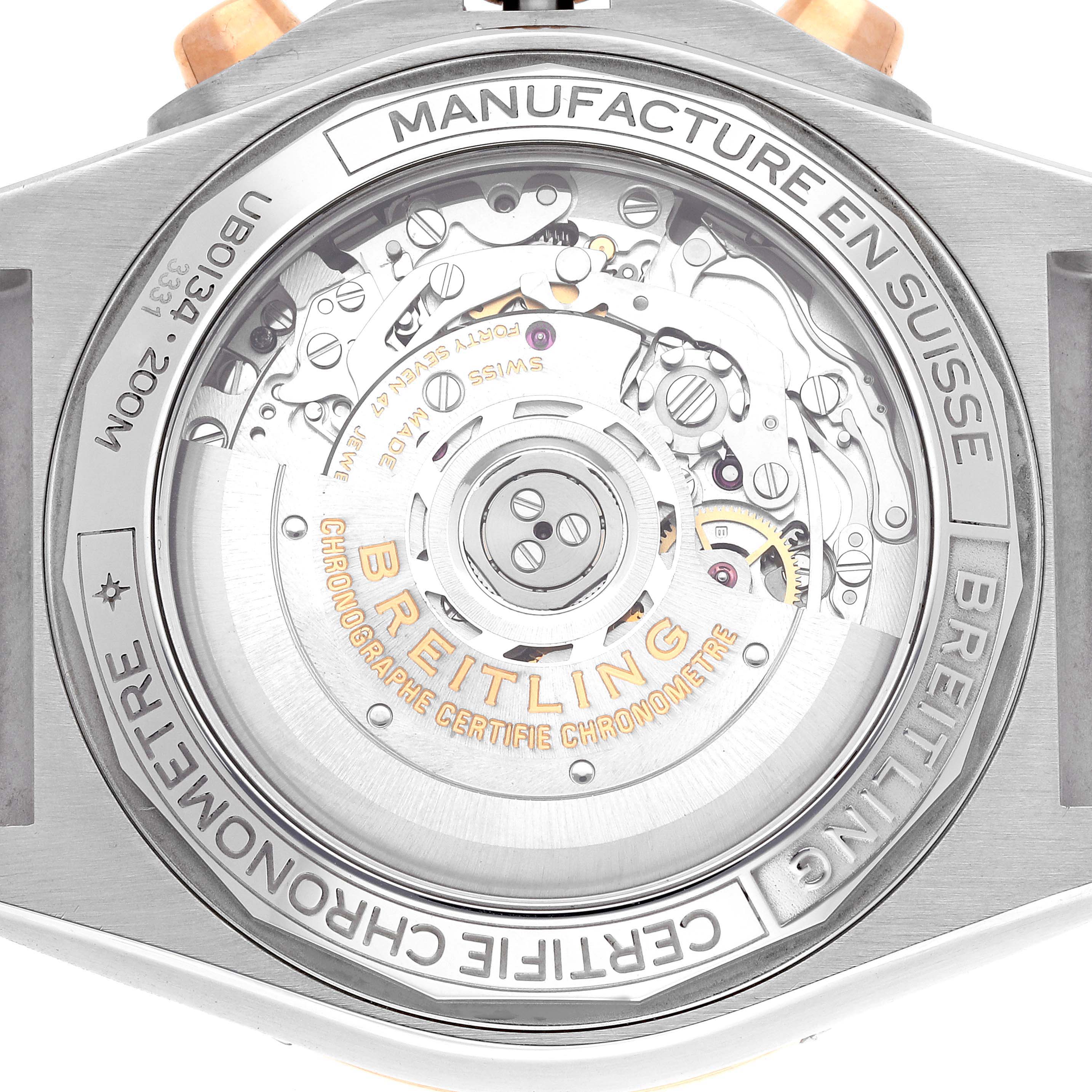 This image shows the caseback view of a Breitling Chronomat UB0134 Men's Steel and Gold (two tone) Grey Dial UB0134 Men's Steel and Gold (two tone) Grey Dial watch, revealing its inner mechanical movement and engravings.