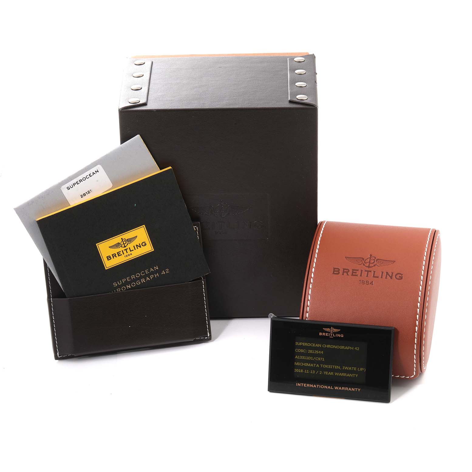 The image shows packaging and accessories for a Breitling Superocean A13311 Men's Stainless Steel Blue Dial A13311 Men's Stainless Steel Blue Dial watch, including a box, manuals, and warranty card.