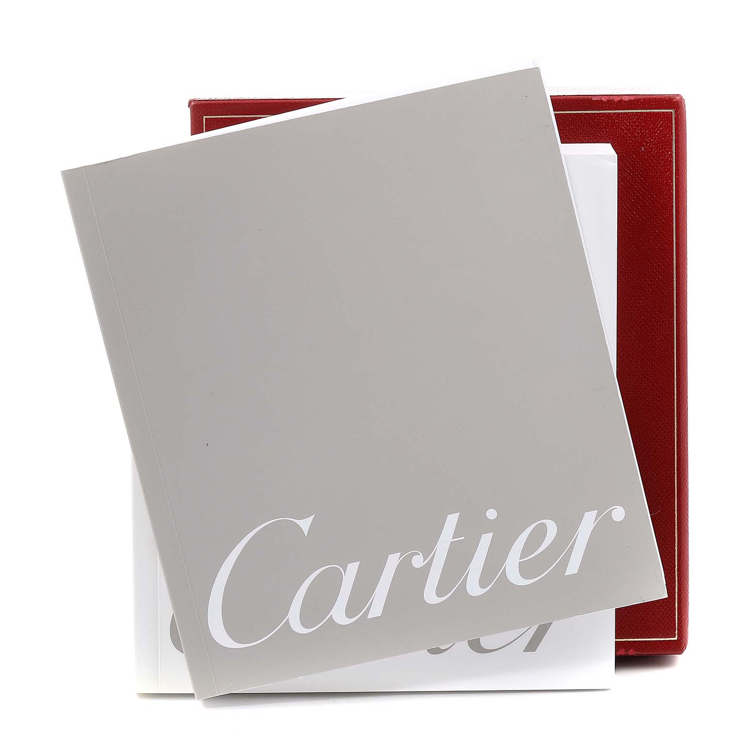 The image shows the Cartier Pasha W31077U2 Men's Stainless Steel Black Dial W31077U2 Men's Stainless Steel Black Dial watch box and accompanying documents, including a grey booklet partially covering the red box.