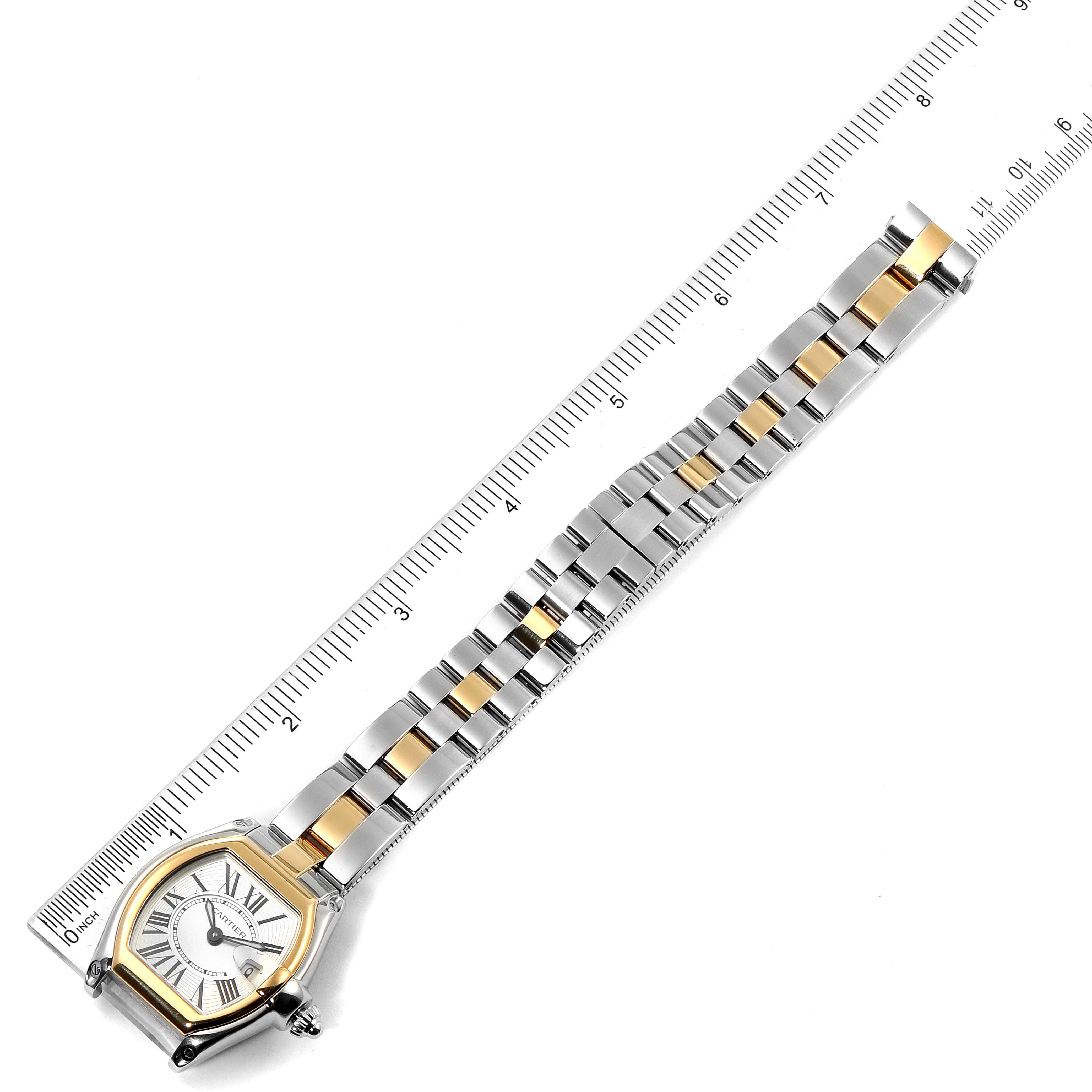 The image shows a Cartier Roadster W62026Y4 Women's Steel and Gold (two tone) Silver Dial W62026Y4 Women's Steel and Gold (two tone) Silver Dial watch laid flat next to a ruler displaying its face and full bracelet.