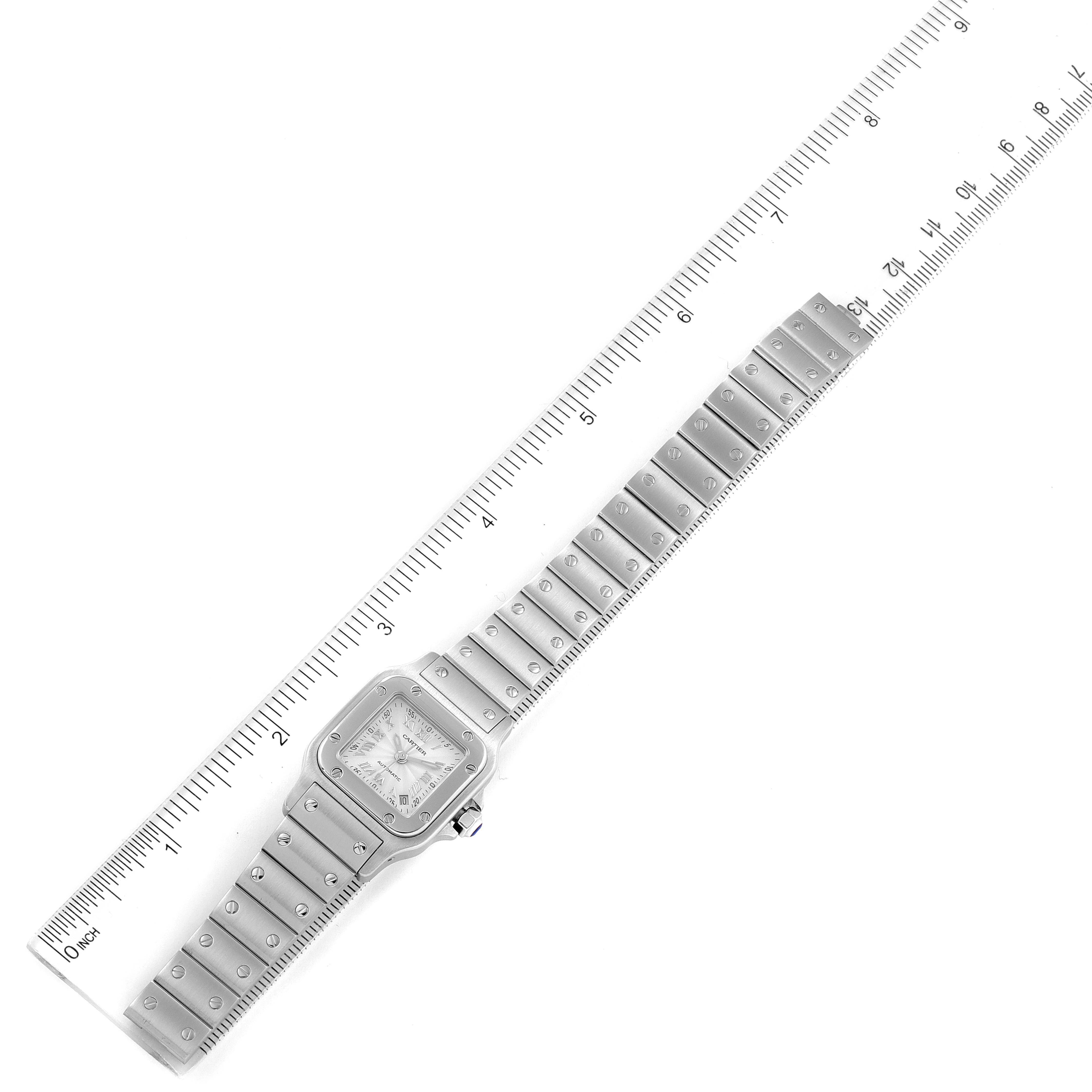 The image shows an overhead view of the Cartier Santos W20044D6 Women's Stainless Steel Silver Dial W20044D6 Women's Stainless Steel Silver Dial watch with a measurement ruler along the bracelet.