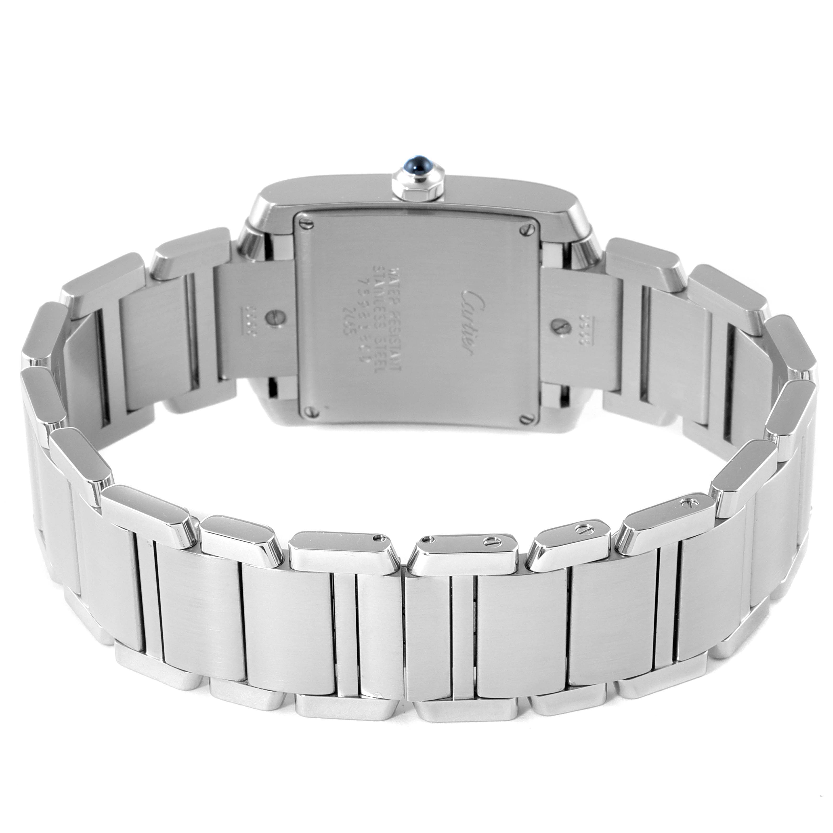 The image shows the back case and bracelet of a Cartier Tank Française watch, highlighting the rear engraving and links.