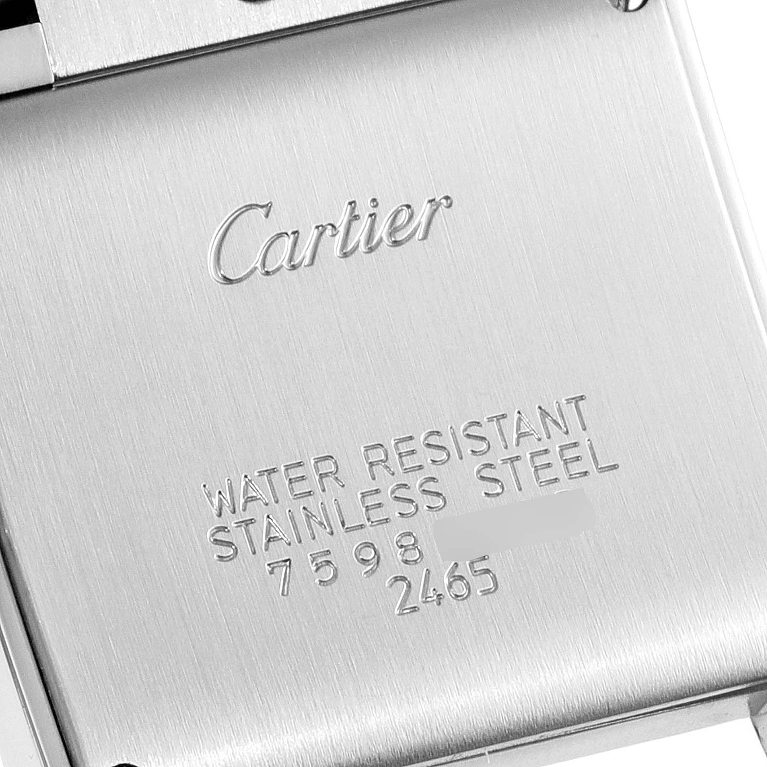 The image shows the engraved case back of a Cartier Tank Française watch, highlighting the brand, material, and water resistance.