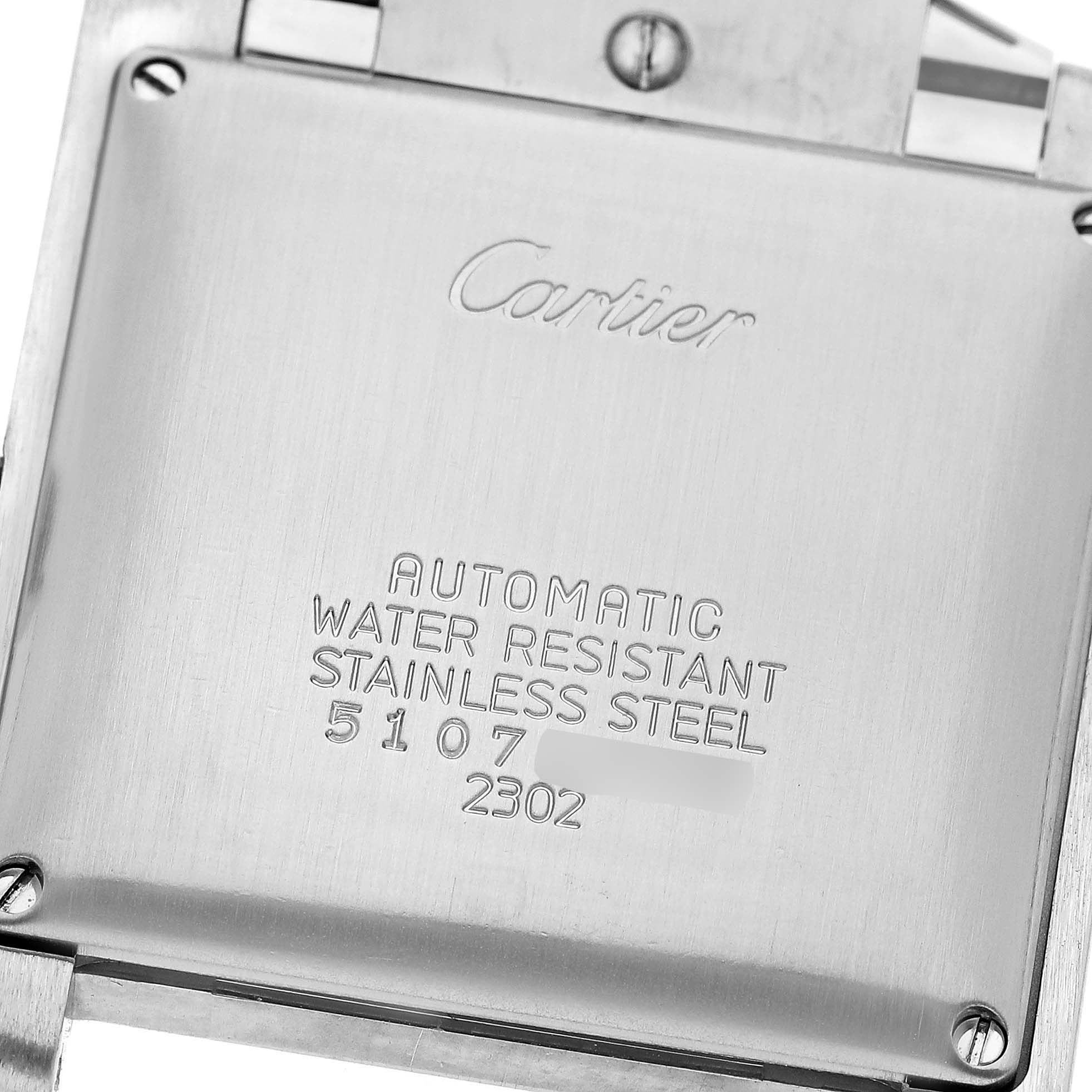 The image shows the back case of a Tank Française model by Cartier, highlighting its engravings and stainless steel finish.