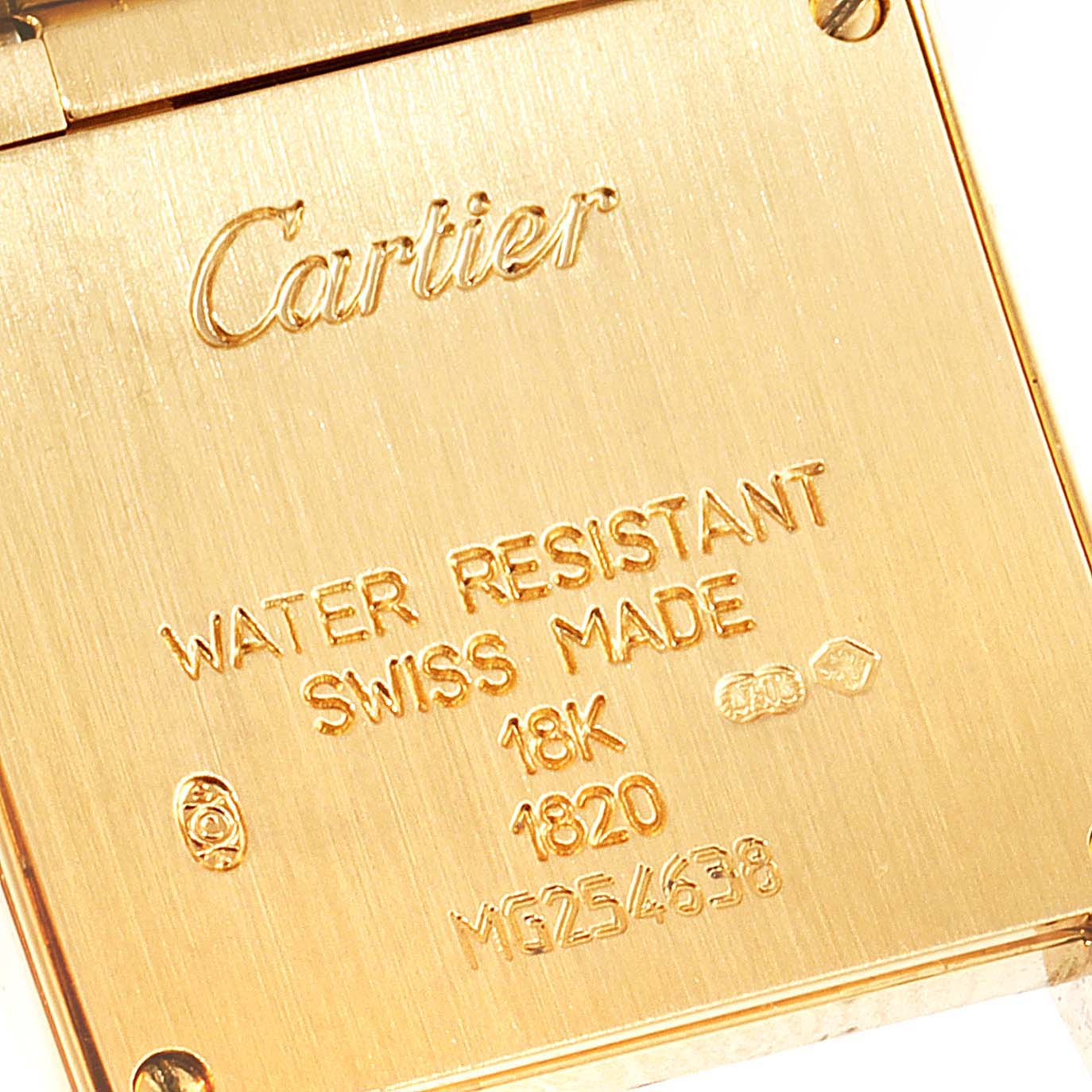 This image shows the back case of a Cartier Tank Francaise W50002N2 Women's Yellow Gold Silver Dial W50002N2 Women's Yellow Gold Silver Dial watch, highlighting engravings such as "Cartier" and specifications.