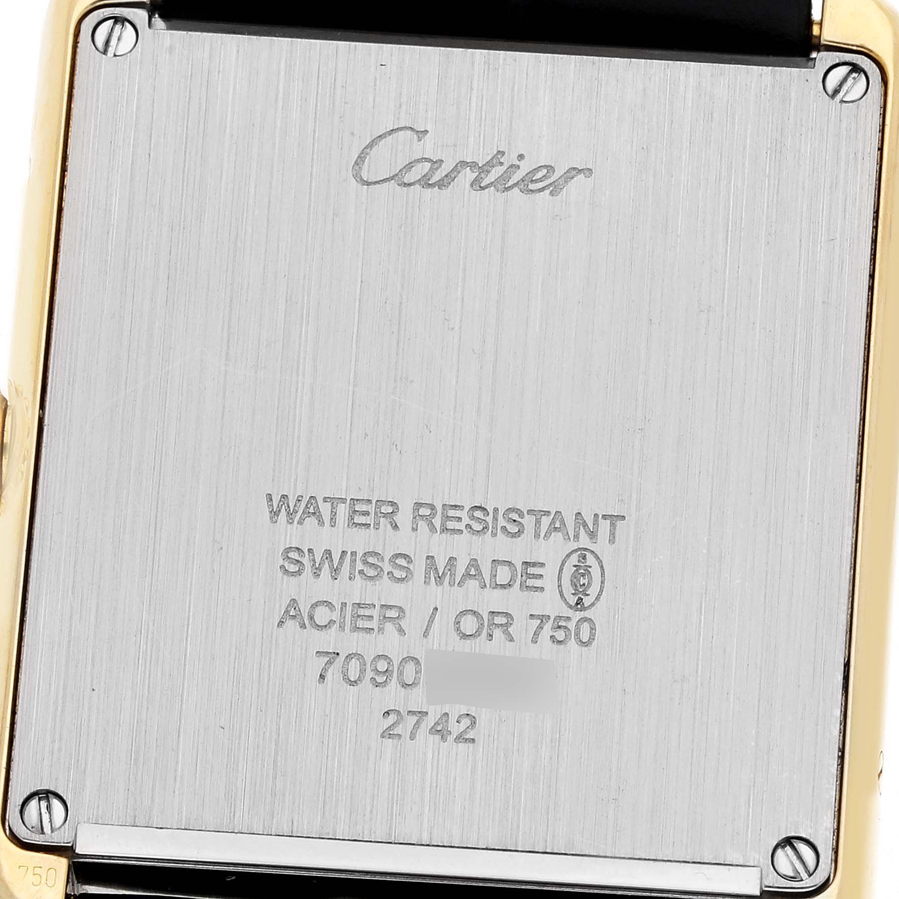 This image shows the back case of the Cartier Tank Solo W1018855 Men
s Steel and Gold (two tone) Silver Dial W1018855 Men
s Steel and Gold (two tone) Silver Dial watch, featuring inscriptions about its water resistance and Swiss origin.