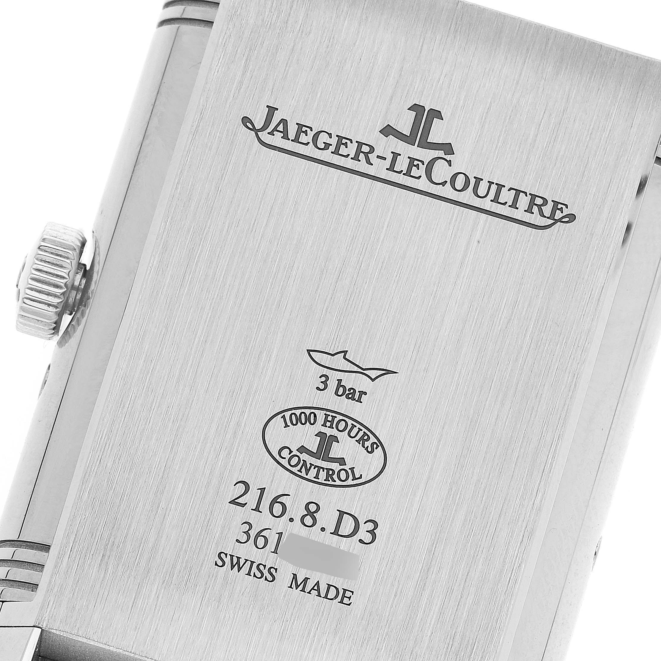 The image shows the back case of a Jaeger-LeCoultre Reverso watch, including the crown and engraved details.