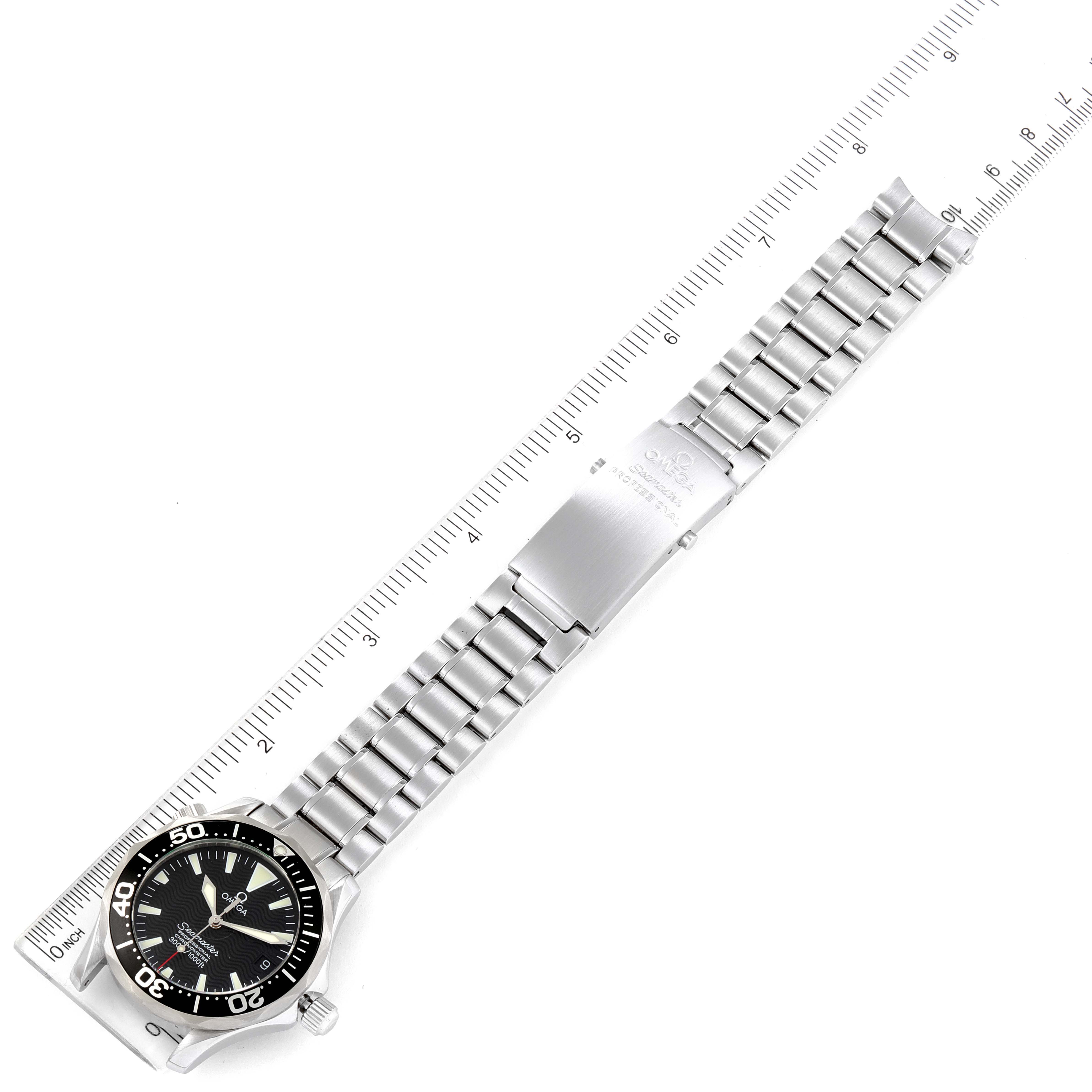 The image shows an Omega Seamaster 2252.50.00 Men's Stainless Steel Black Dial 2252.50.00 Men's Stainless Steel Black Dial watch laid flat with a ruler for scale, displaying the dial, bezel, case, and bracelet.
