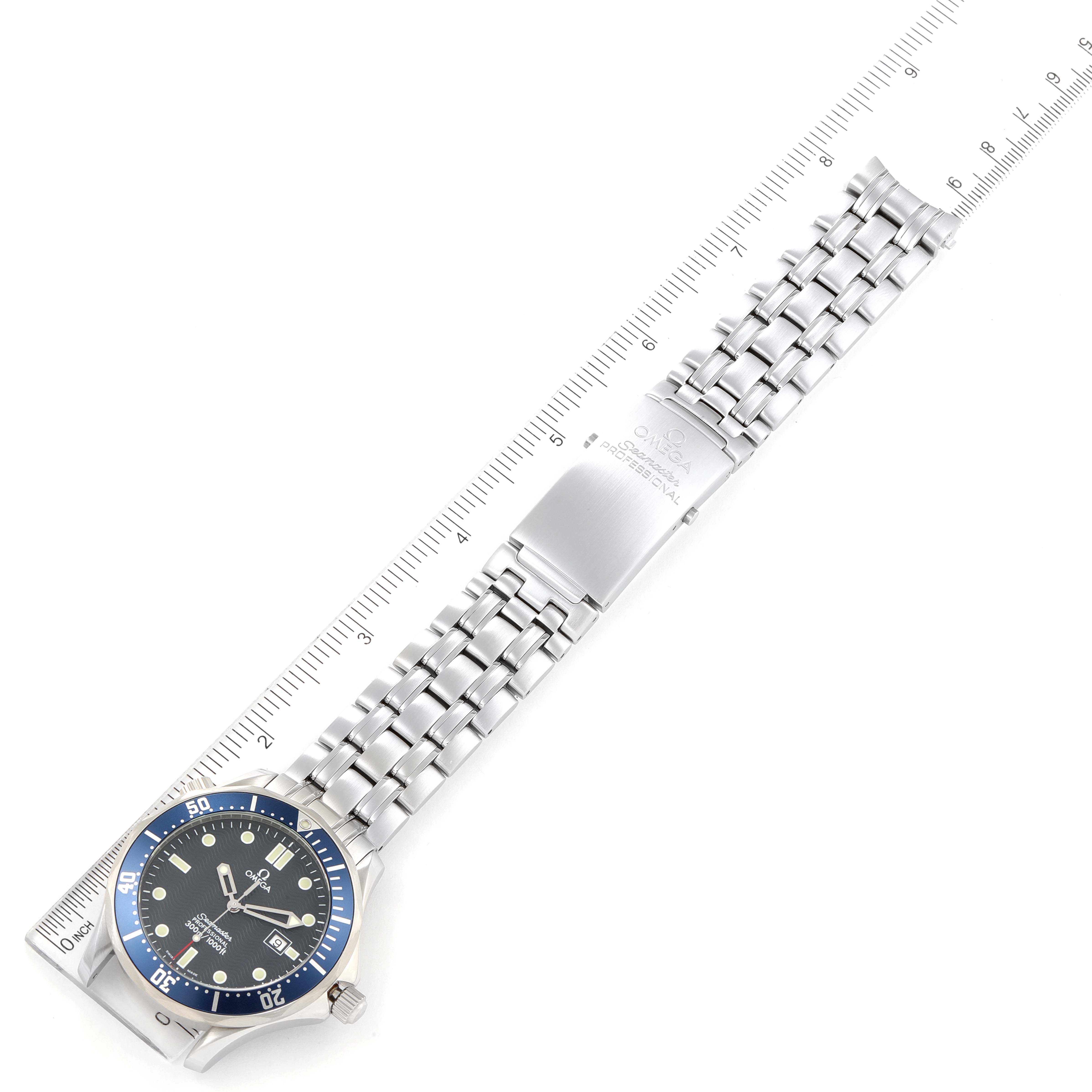 The image shows an overhead view of an Omega Seamaster 2541.80.00 Men's Stainless Steel Blue Dial 2541.80.00 Men's Stainless Steel Blue Dial watch, displaying the face, bezel, and entire metal bracelet alongside a ruler.