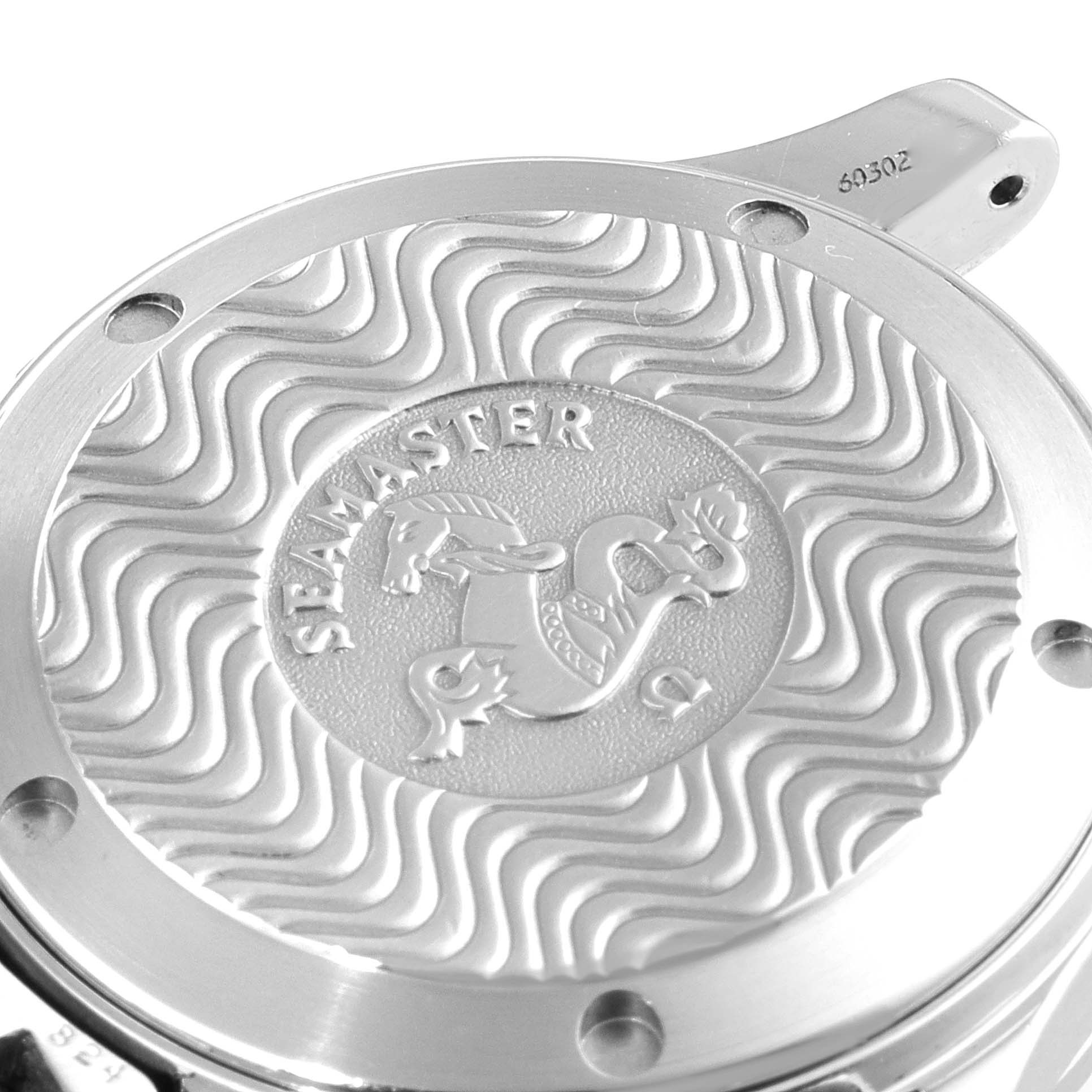 The image shows the case back of the Omega Seamaster 2551.80.00 Men's Stainless Steel Blue Dial 2551.80.00 Men's Stainless Steel Blue Dial watch with its wave pattern and engraved emblem.