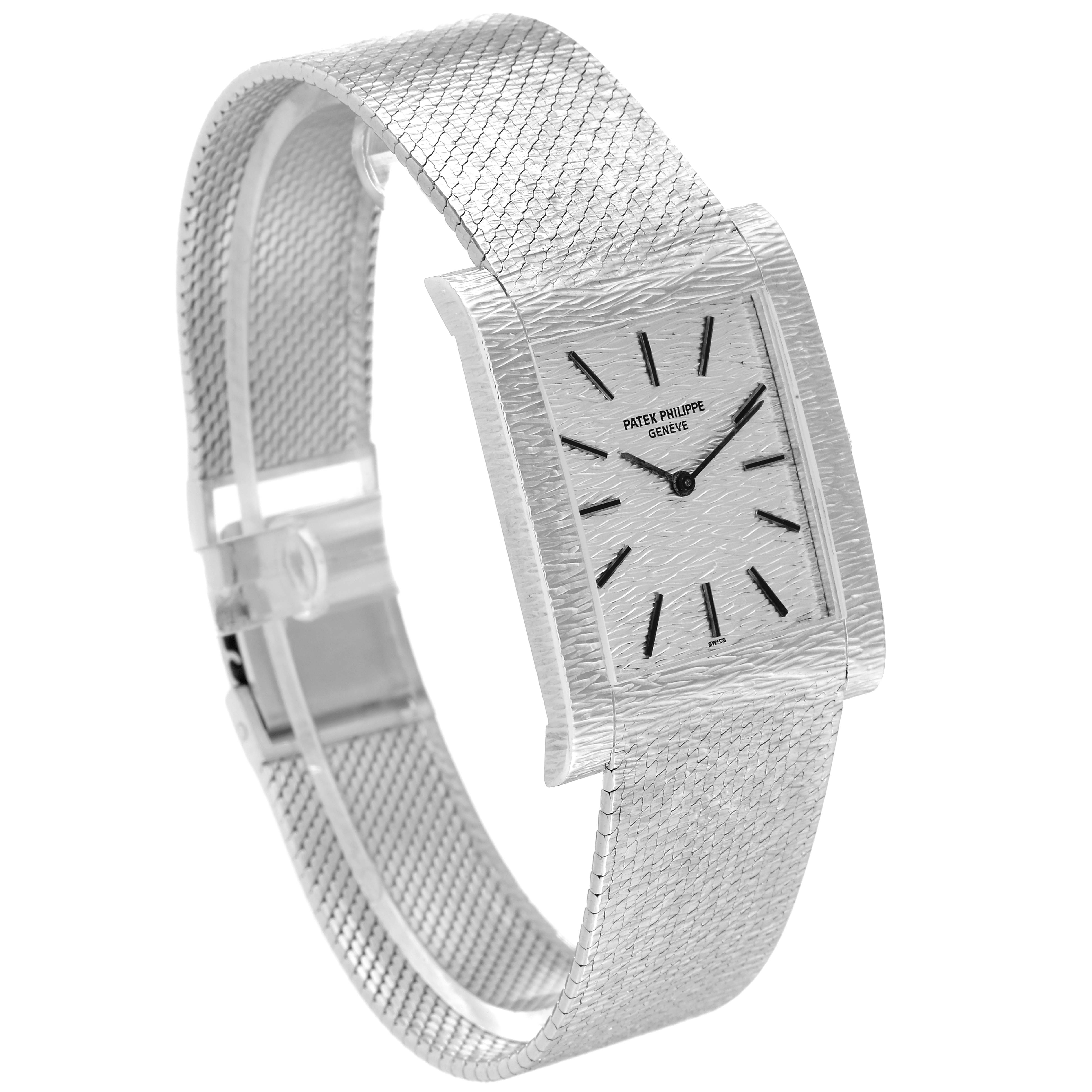 This image shows a side-angle view of a Vintage Patek Philippe watch, highlighting its rectangular face and textured metal bracelet.