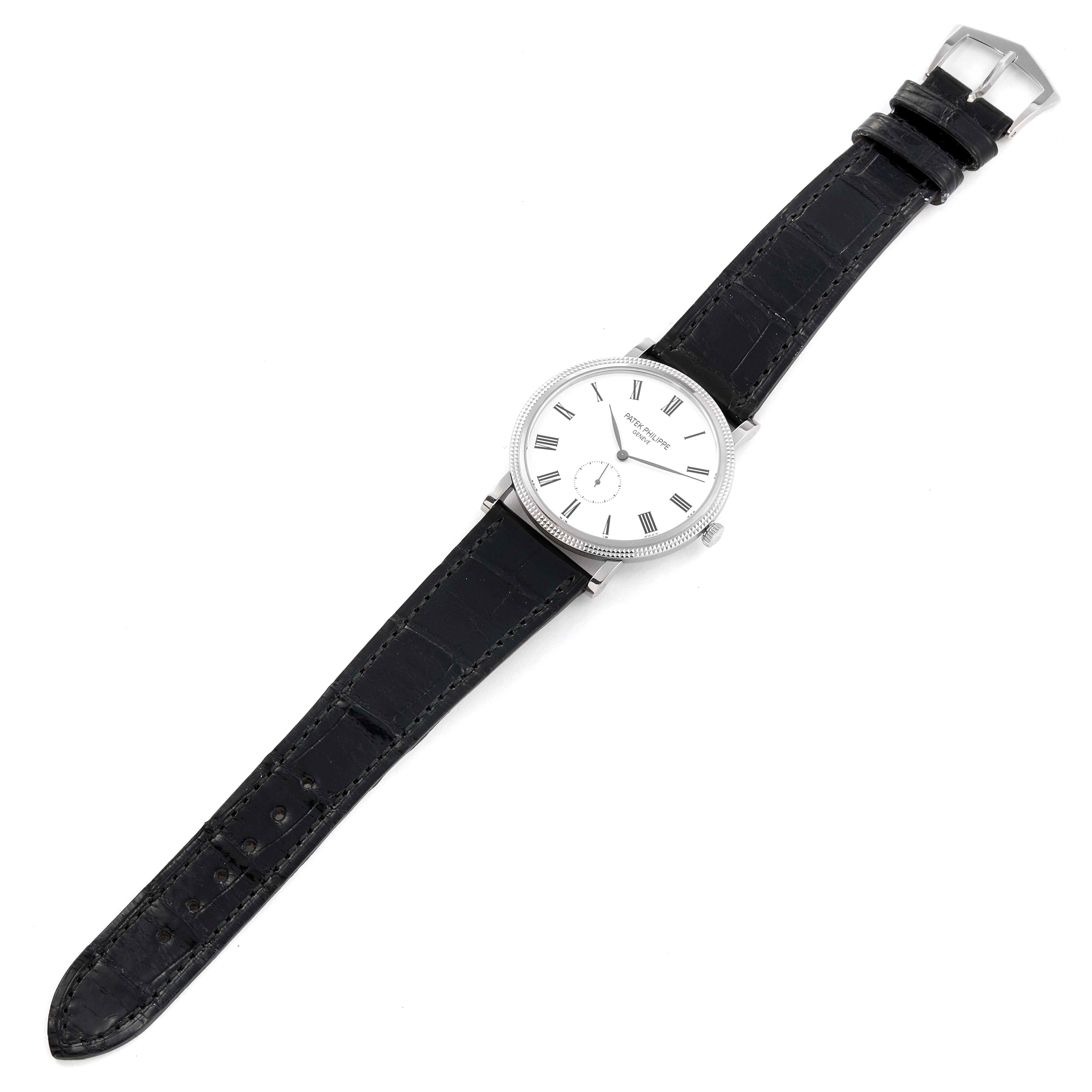 This image shows a Patek Philippe Calatrava 5119G Men
s White Gold White Dial 5119G Men
s White Gold White Dial watch laid flat, displaying the face, leather strap, and buckle.