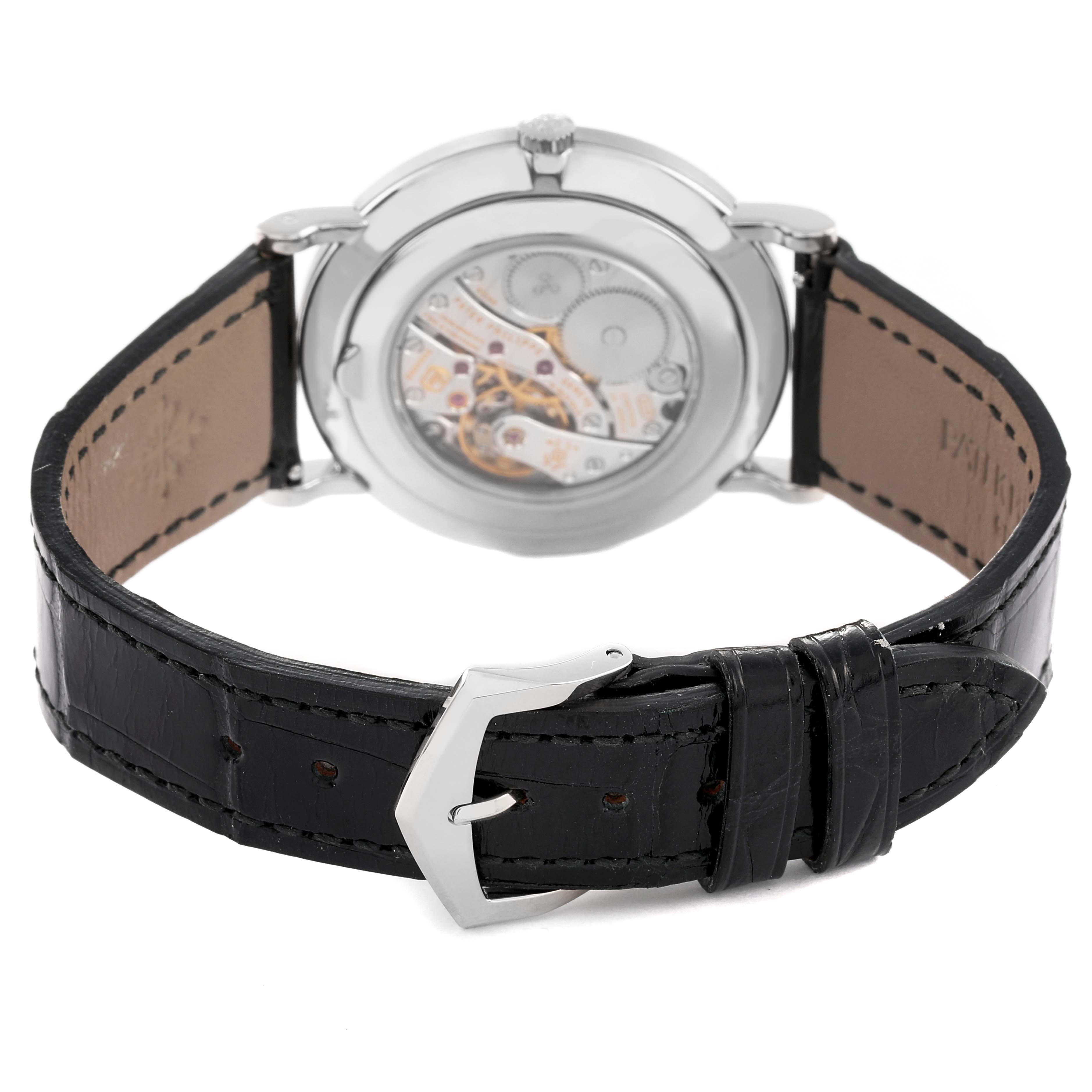 This image shows the back view of a Patek Philippe Calatrava 5119G Men
s White Gold White Dial 5119G Men
s White Gold White Dial watch, highlighting the leather strap and the watch
s exposed mechanical movement.