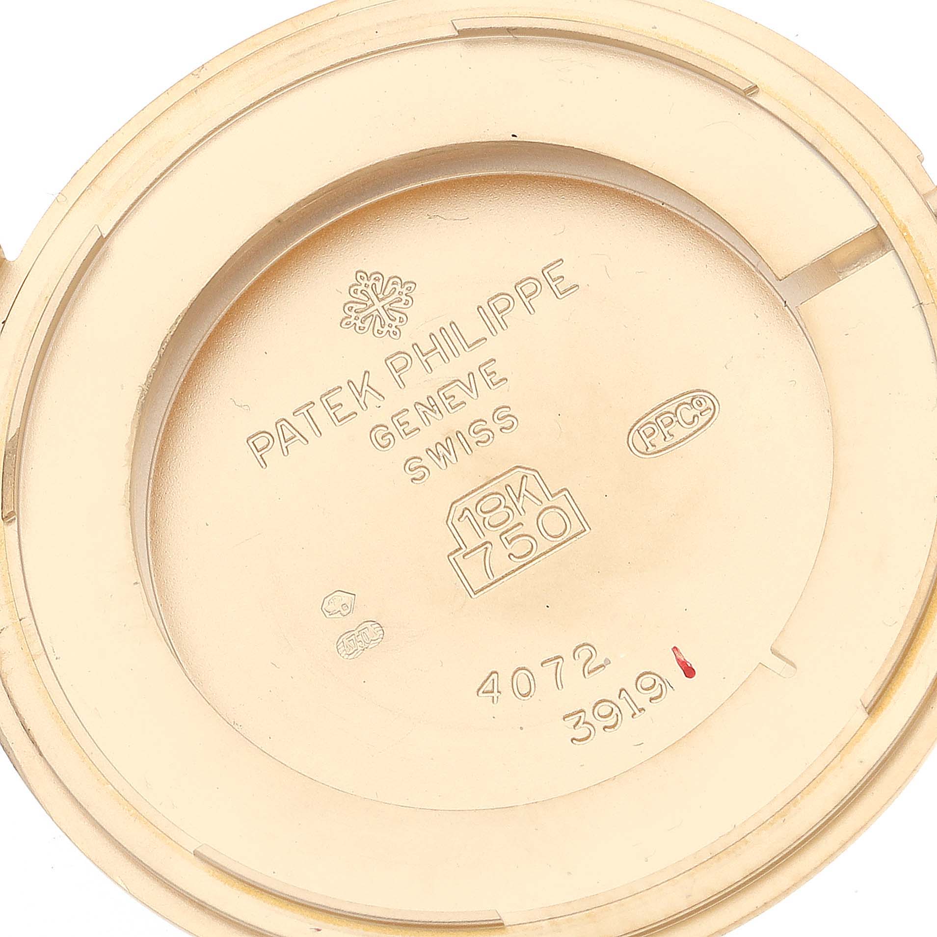 This image shows the inner case back of a Patek Philippe Calatrava 3919J Men's Yellow Gold White Dial 3919J Men's Yellow Gold White Dial watch, displaying branding, material, and reference numbers.