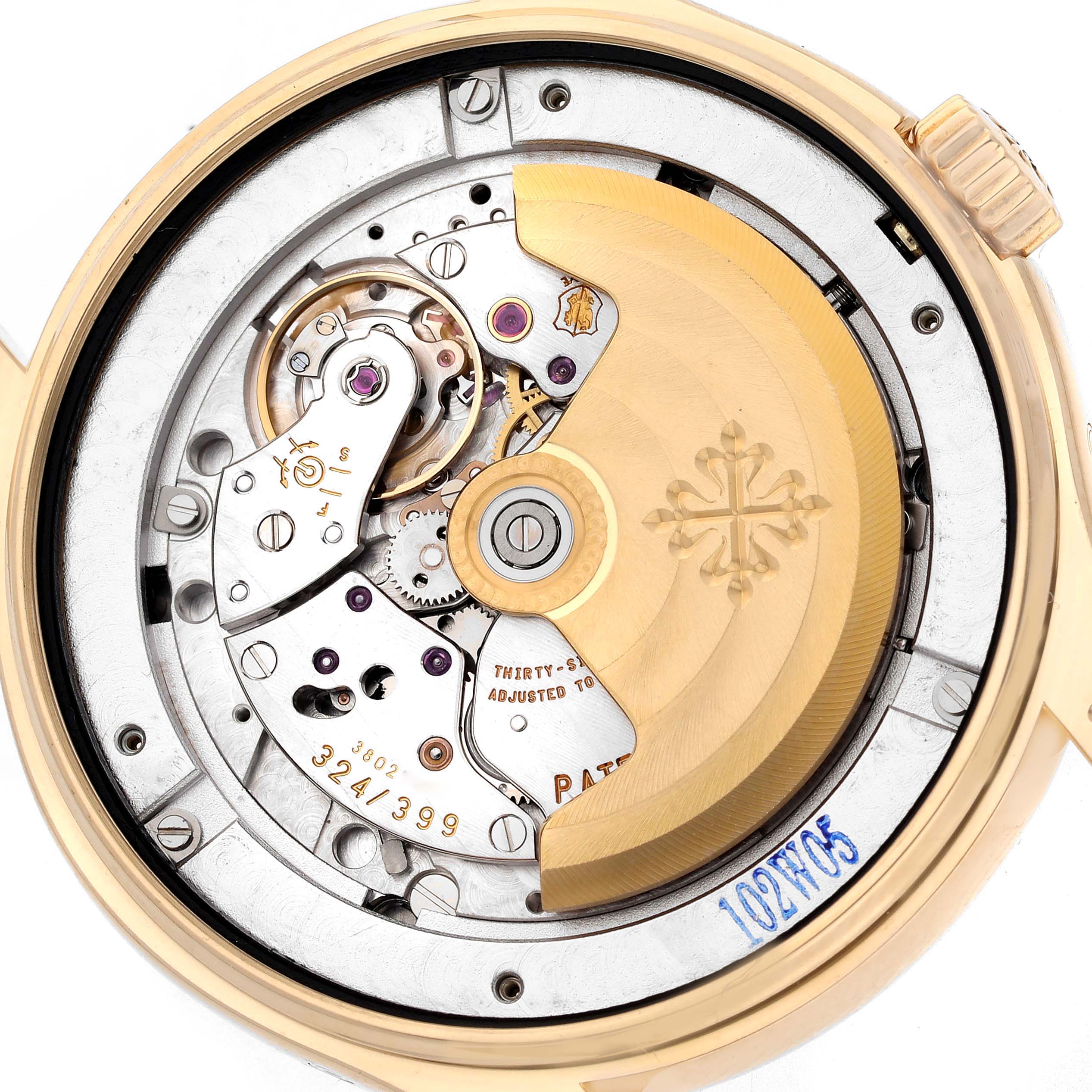 The image shows the back view of a Patek Philippe Complications 5146J Men's Yellow Gold Beige Dial 5146J Men's Yellow Gold Beige Dial watch, focusing on its intricate movement and rotor.