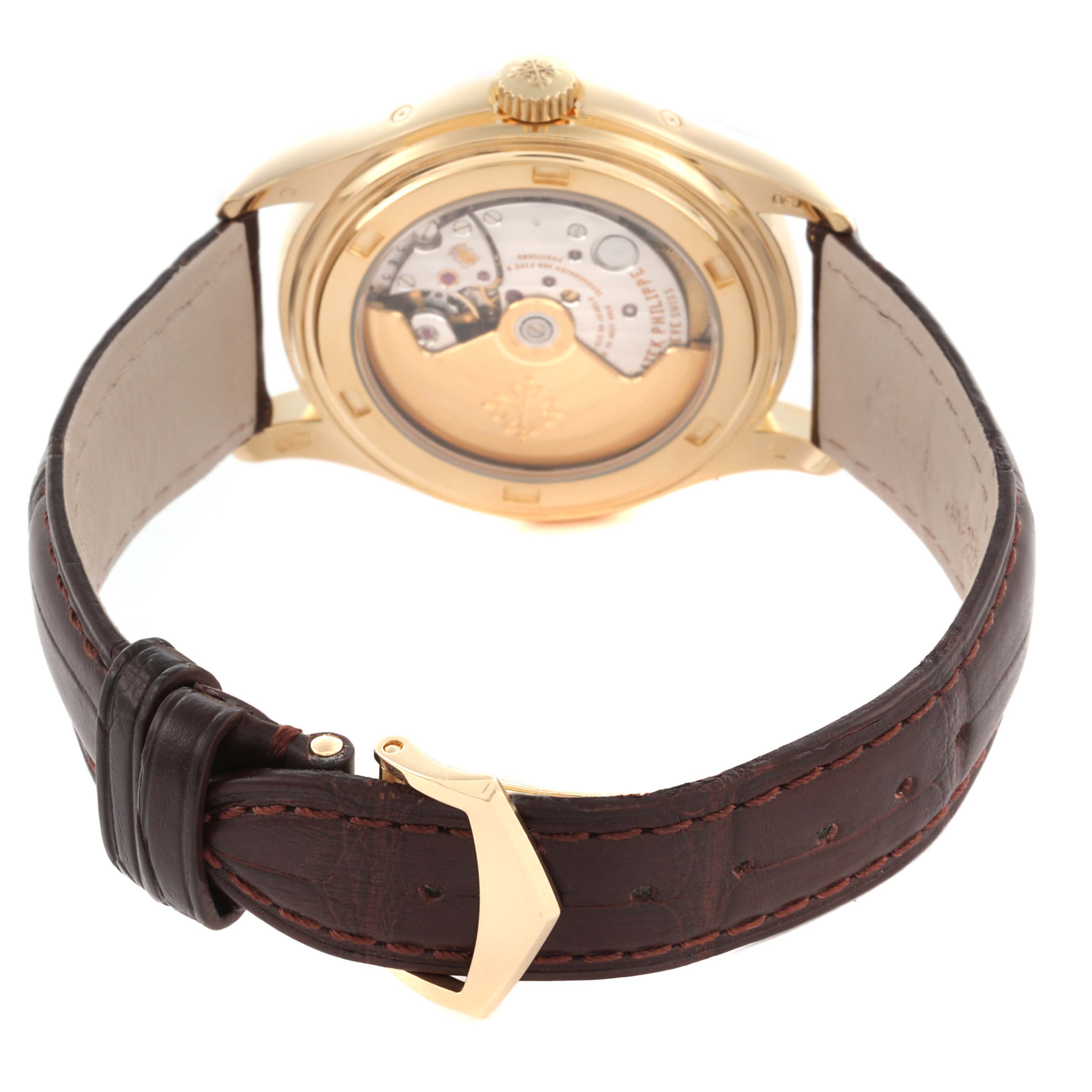 The image shows the back of a Patek Philippe Complications 5146J Men's Yellow Gold Beige Dial 5146J Men's Yellow Gold Beige Dial watch with a gold case and leather strap.