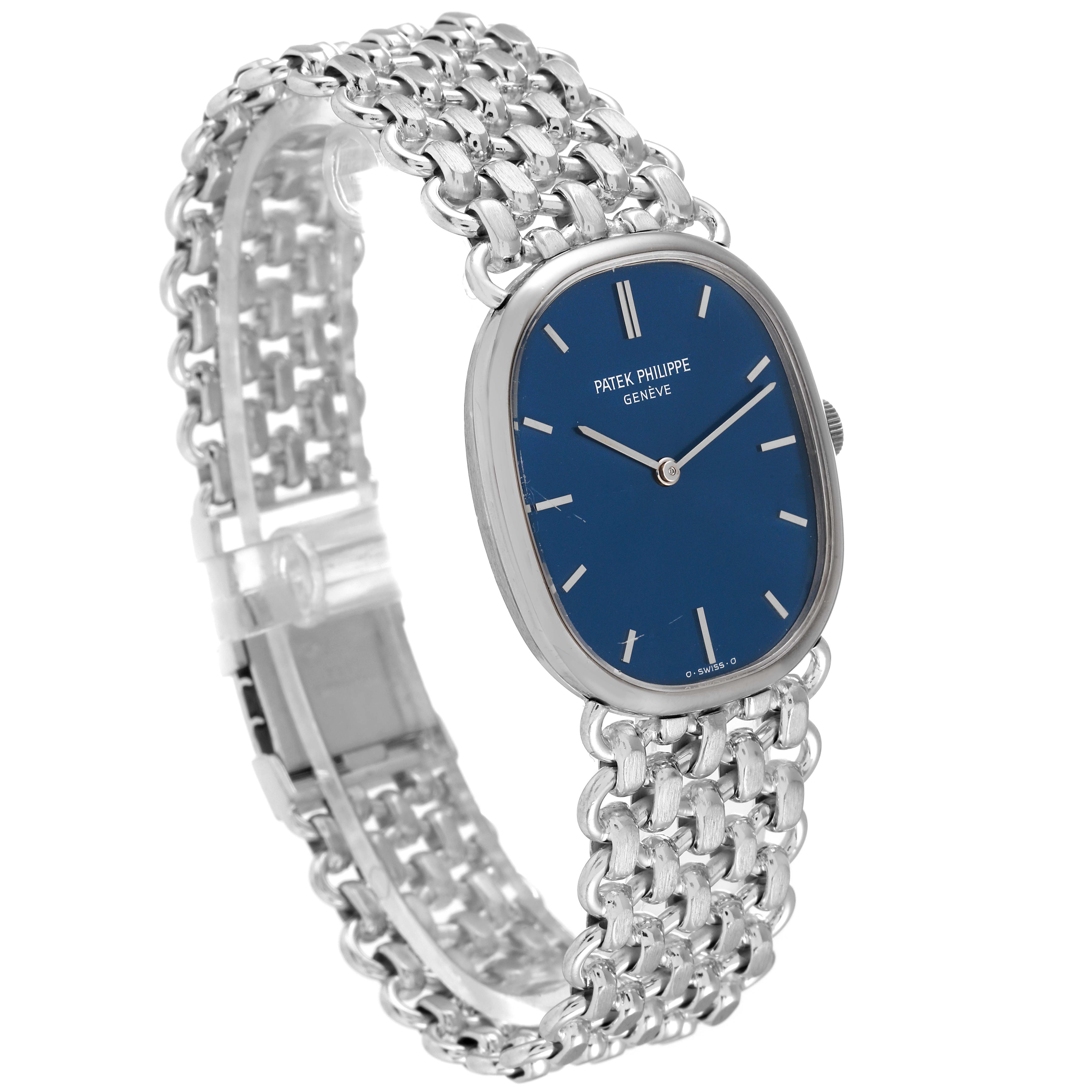 This image shows a Vintage Patek Philippe watch at a three-quarter angle, highlighting its blue dial and silver chain bracelet.