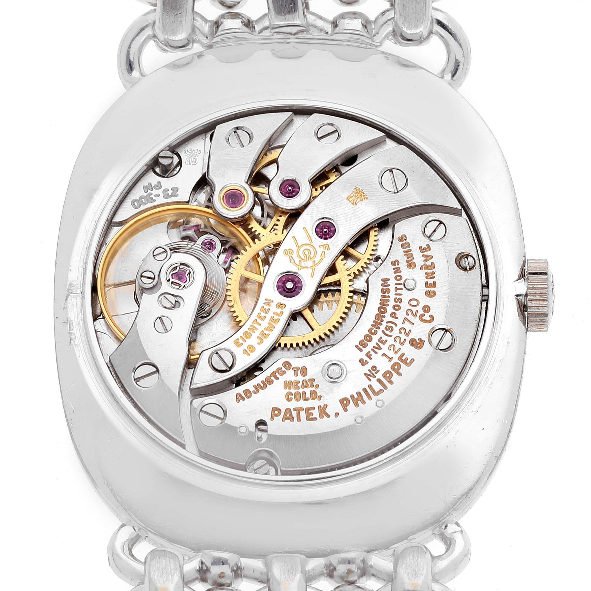 This image shows the movement and inner mechanisms of a vintage Patek Philippe watch from a back angle.