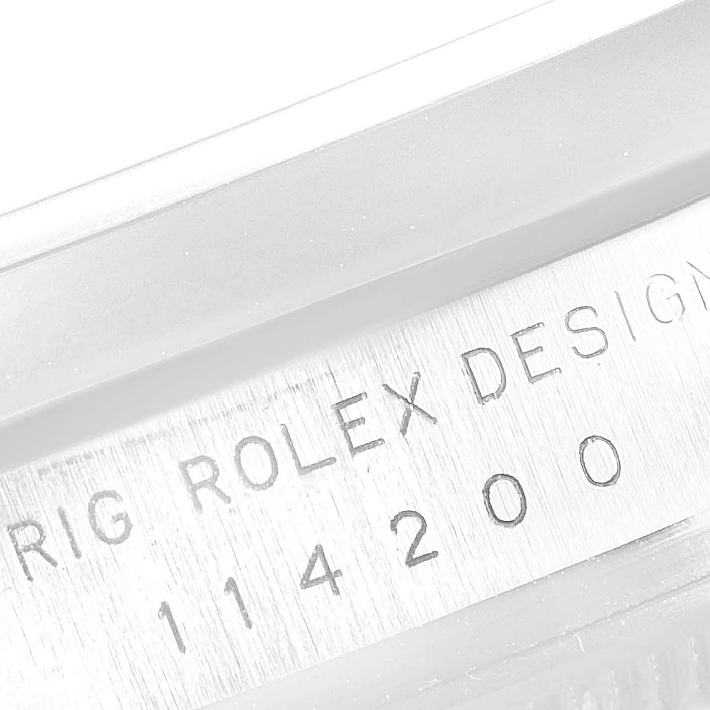 This image shows the engraved model and serial number on the case side of a Rolex Air-King 114200 Men's Stainless Steel Silver Dial 114200 Men's Stainless Steel Silver Dial watch, viewed in close-up.